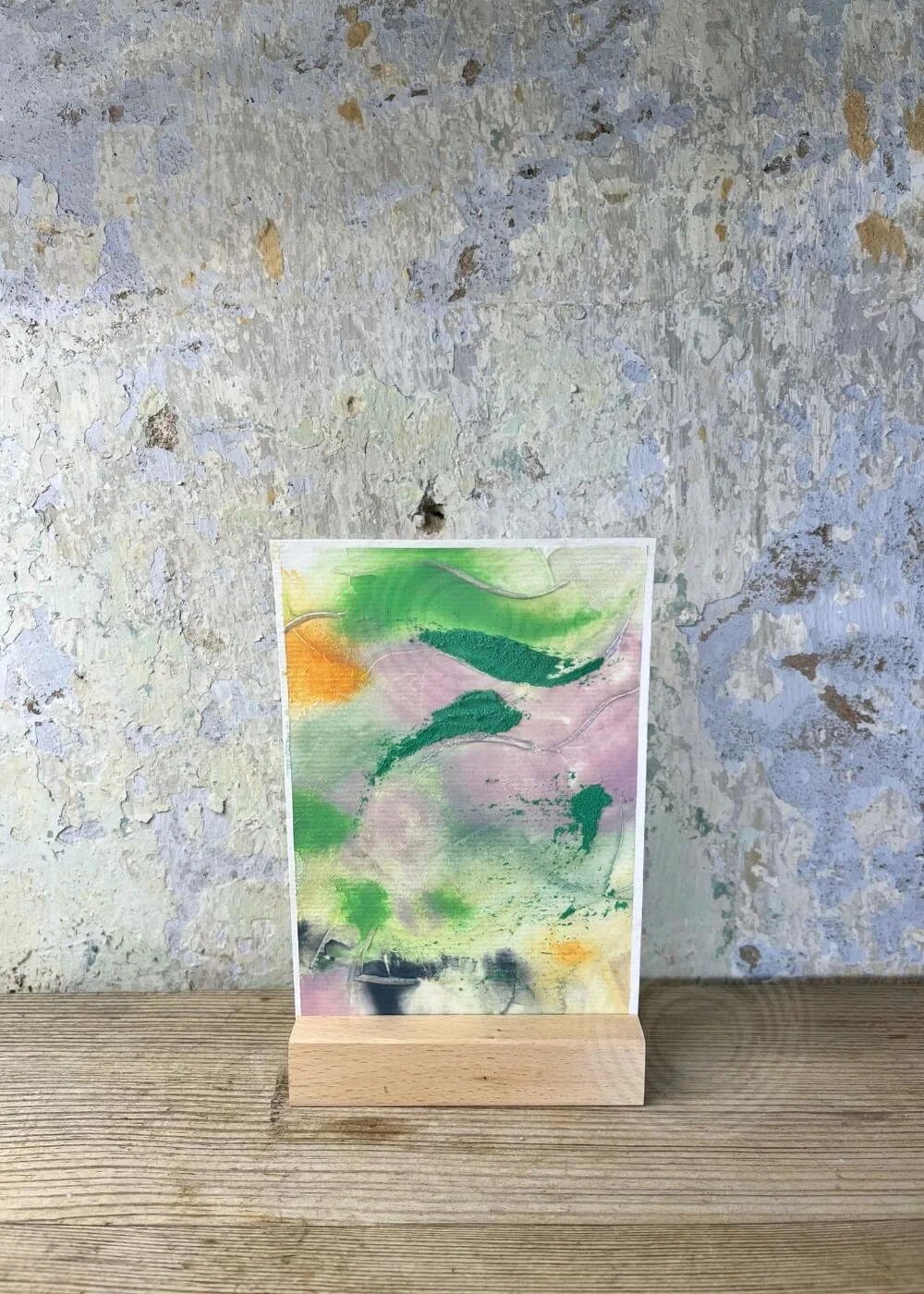 Abstract artwork ‘What was and what will be’ from the Silver Feathers Rising series – textured layers in green, orange, and lilac tones symbolizing transition, healing, and renewal.