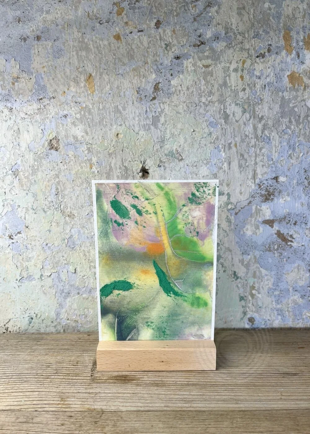 Abstract artwork ‘Roots of Light’ from the Silver Feathers Rising collection – textured layers in green, lilac, and orange with silver highlights, symbolizing grounding, healing, and renewal.