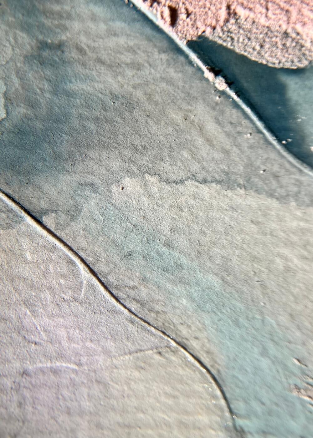 Macro detail of textured surface from “A whisper of tomorrow”, showing raised blush-pink areas and smooth blue glaze, highlighting tactile serenity.