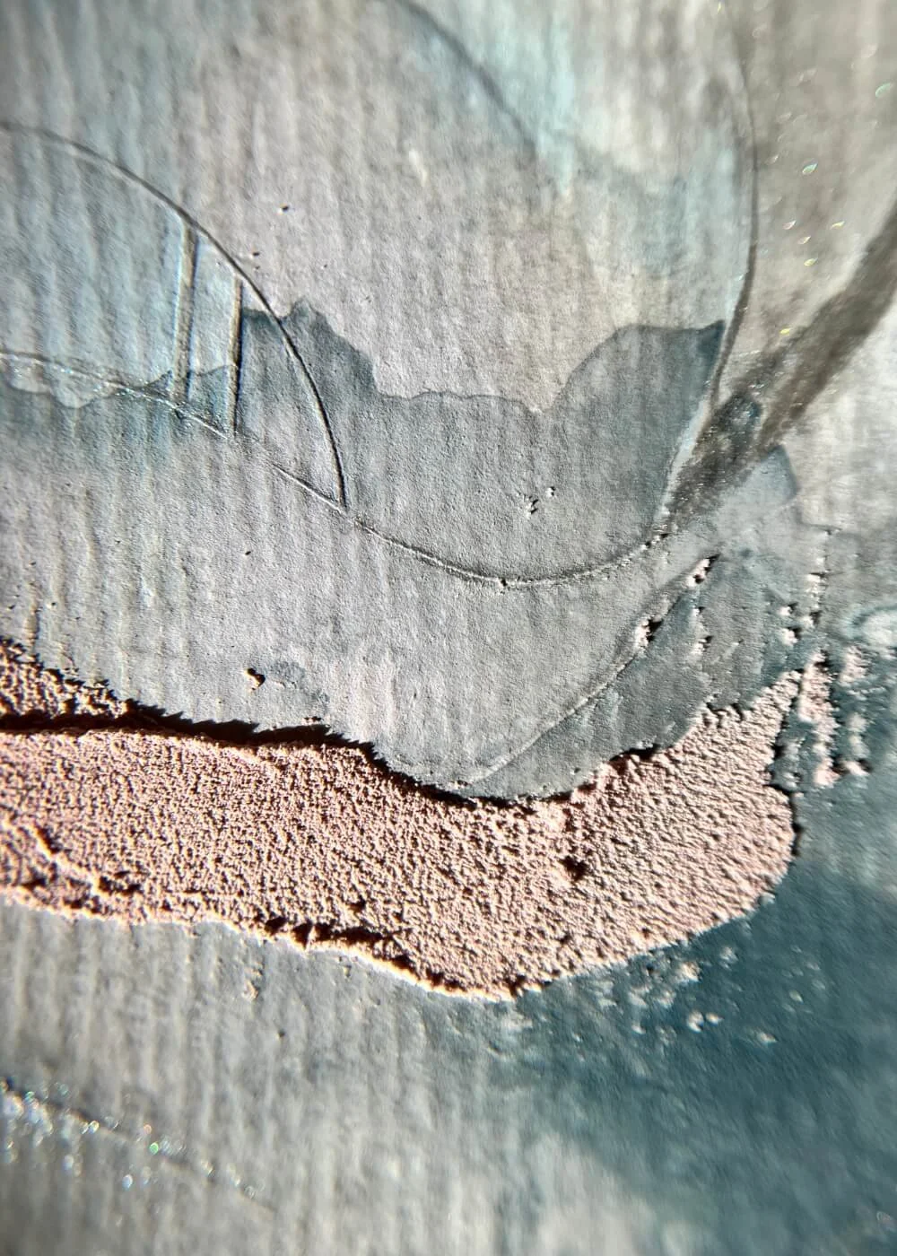 Macro view of blush and blue textures merging softly on a tactile surface, illustrating the subtle movement of calm beneath stillness.