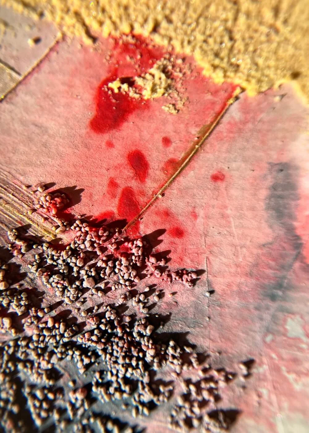 A close view reveals delicate beads and fluid stains — the memory of fire made tender, resilient, and whole.