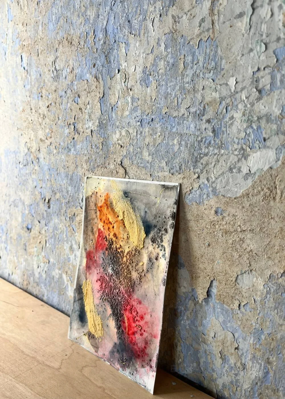 The painting leans gently to the side, its surface breathing warmth and tension — as if gold had learned to listen to rage.