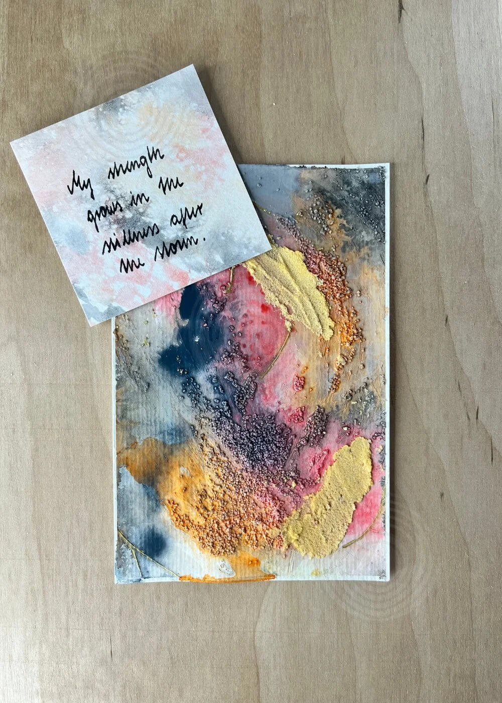 A small card rests beside it, reading “My strength grows in me, minute after minute.” — a promise rising gently from the ashes.