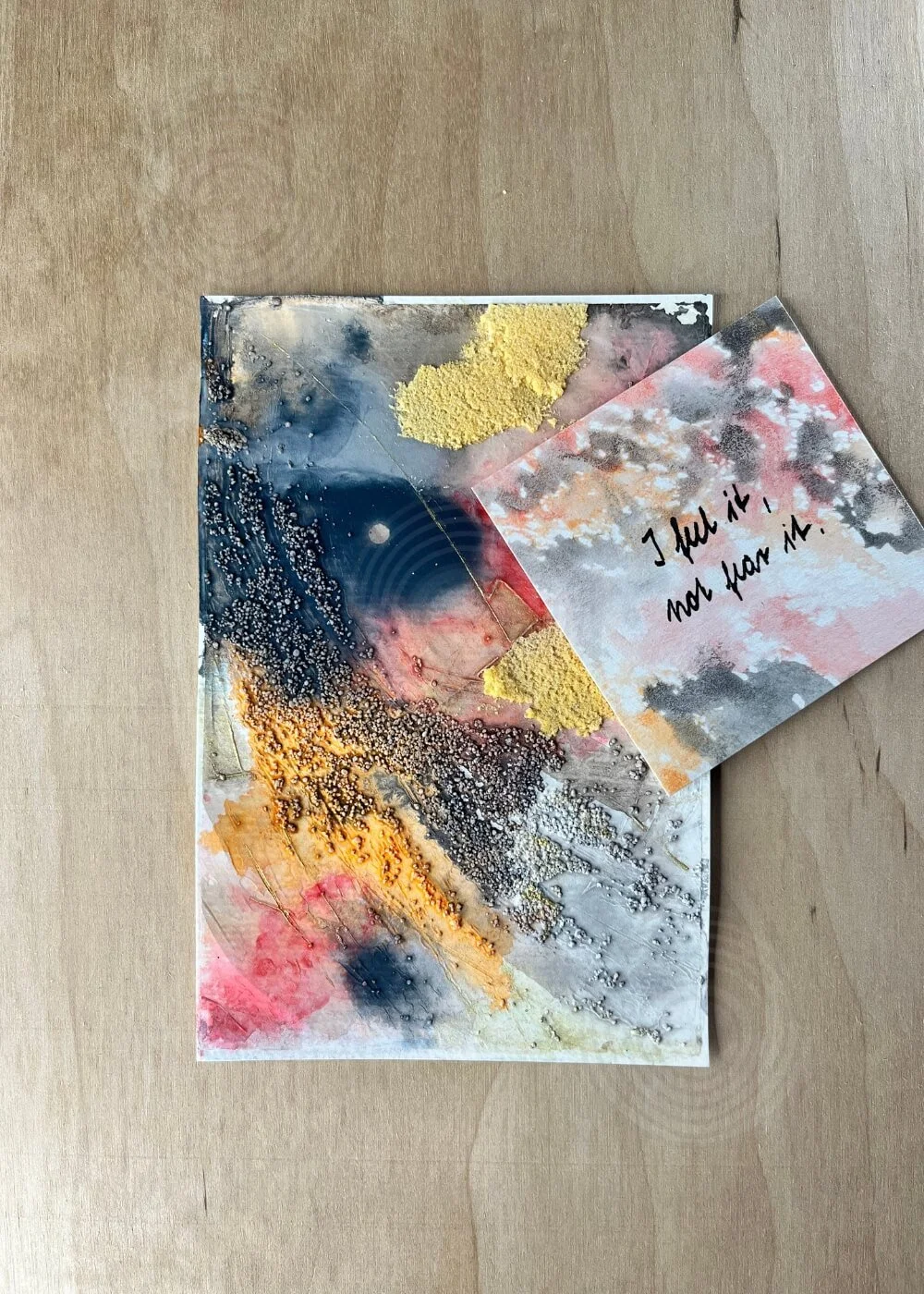 A small card beside the piece reads “I feel it, not fear it.” — a tender affirmation of release and returning to trust.