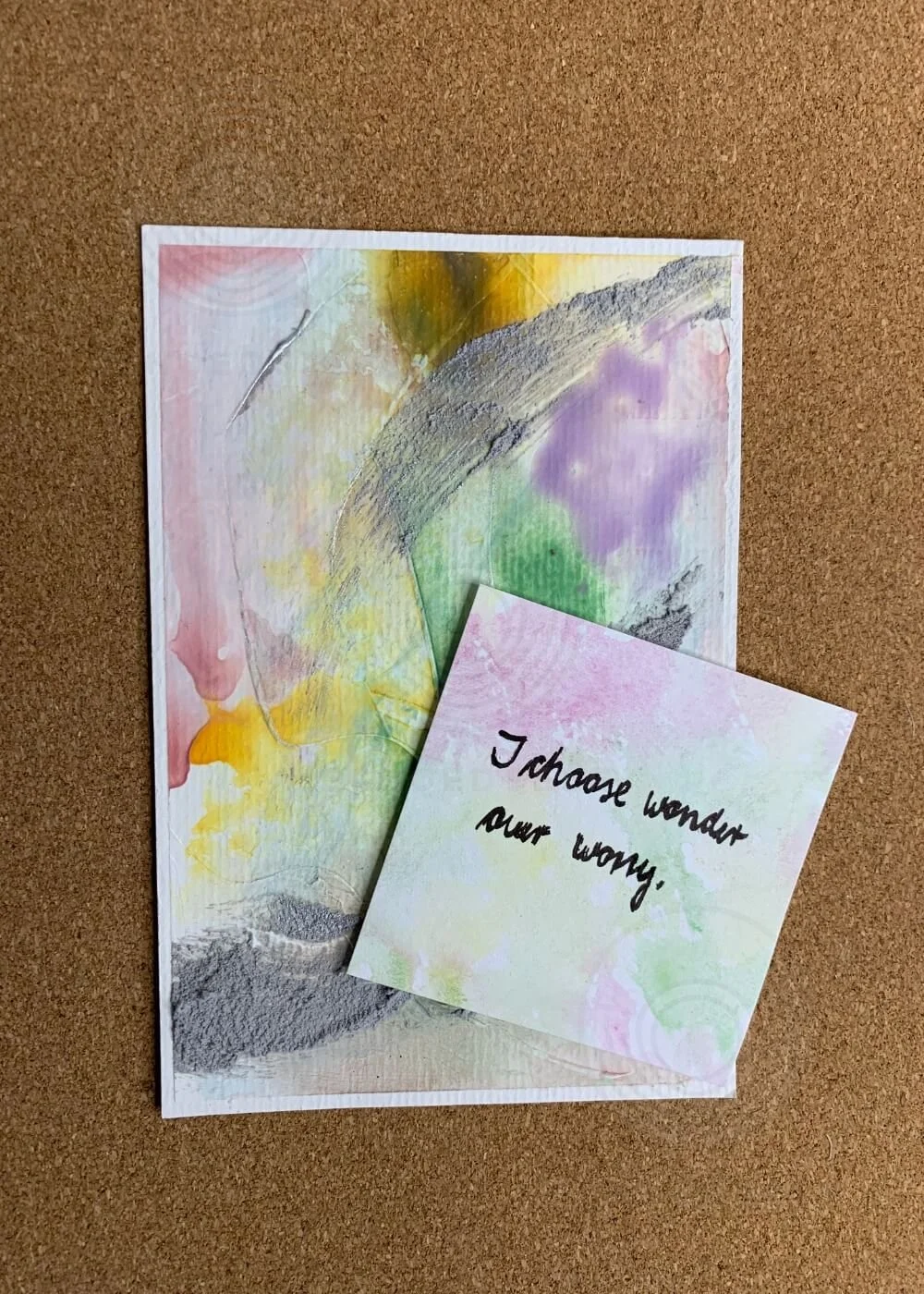 Abstract artwork "Between the Second No. 8" in green, yellow, and purple with textured grey strokes, accompanied by a pastel affirmation card reading “I choose wonder over worry.”
