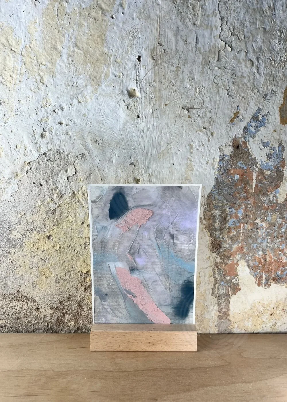 Textured abstract artwork in soft blush and blue tones from the Between Breaths series — And Everything Turns Translucent, representing the gentle unveiling of inner peace.