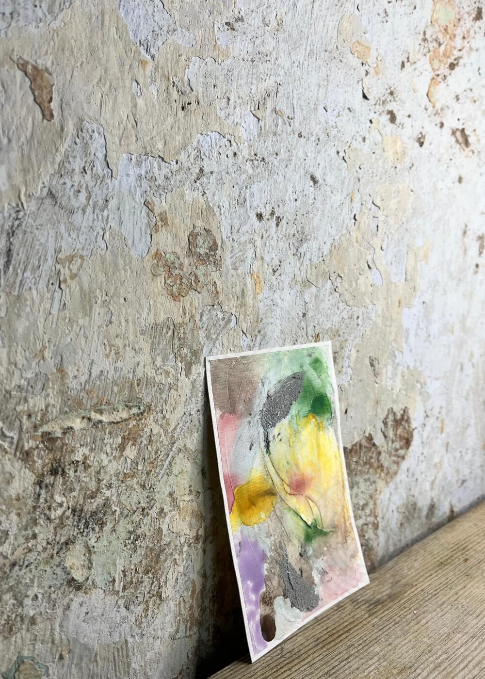 Abstract pastel artwork "Between the Seconds No. 7"  leaning at an angle against a textured wall.