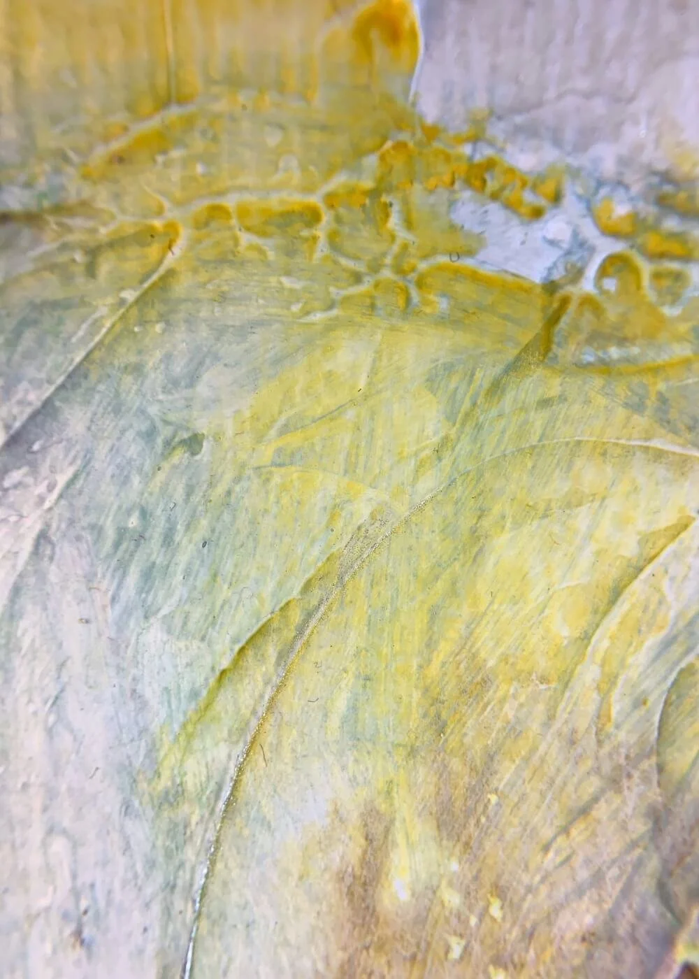 Detailed close-up of the yellow section of the artwork "Between the Seconds No. 10" , showing soft blending, brush strokes, and organic surface patterns.