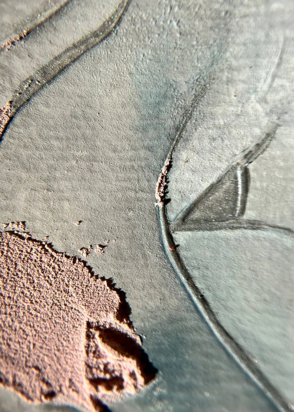 Close-up of delicate surface textures blending rose and slate tones, illustrating the tactile poetry of healing and surrender.