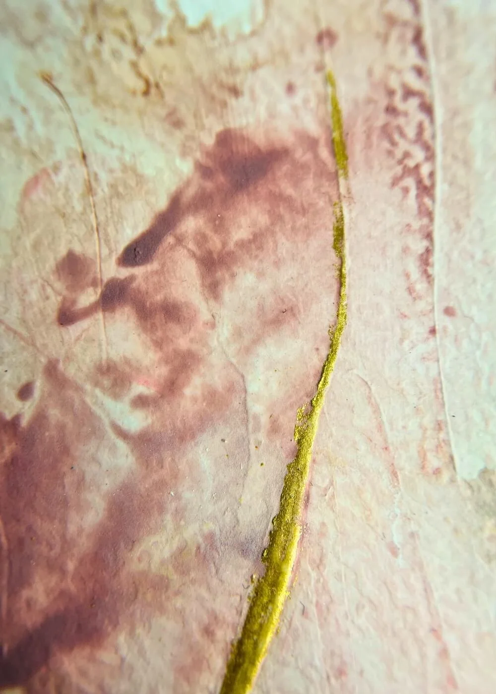 Macro detail of mindfulness art, highlighting pink marbled layers and raised golden strokes representing grounding and inner calm.