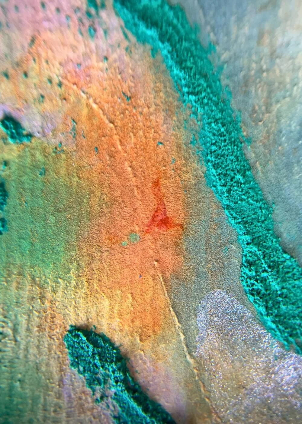 Close-up of orange and emerald textures in ‘Where hope begins to root’, abstract mixed media painting evoking release, renewal, and hope.