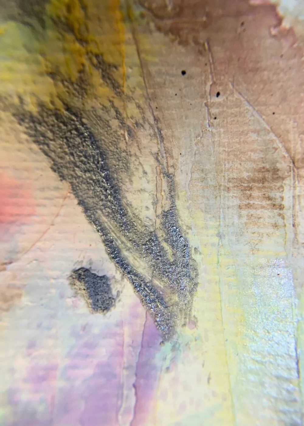 Macro shot of textured paint in grey and muted purple with fine granular surface and layered brushstrokes.