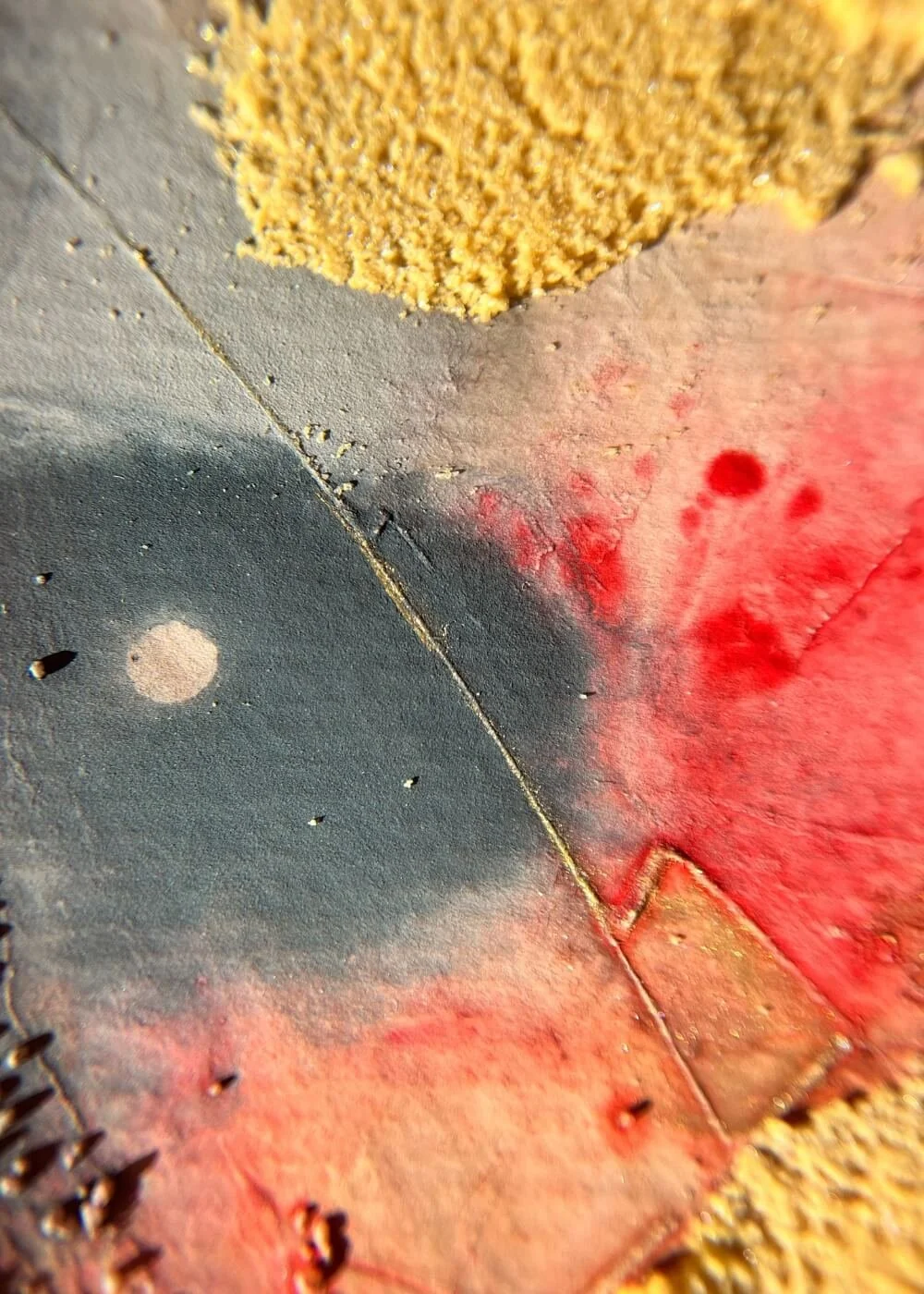 A close-up reveals a pale circle amidst deep hues — the calm center of a once-burning storm, glowing like a distant moon.