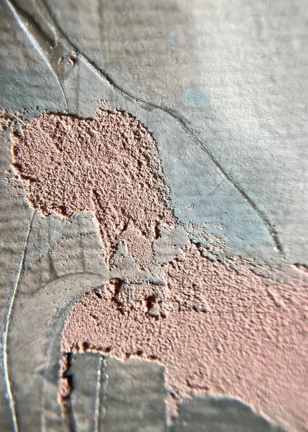 Macro detail of rough blush texture blending with smooth grey-blue surface, highlighting the quiet transitions between feeling and thought.