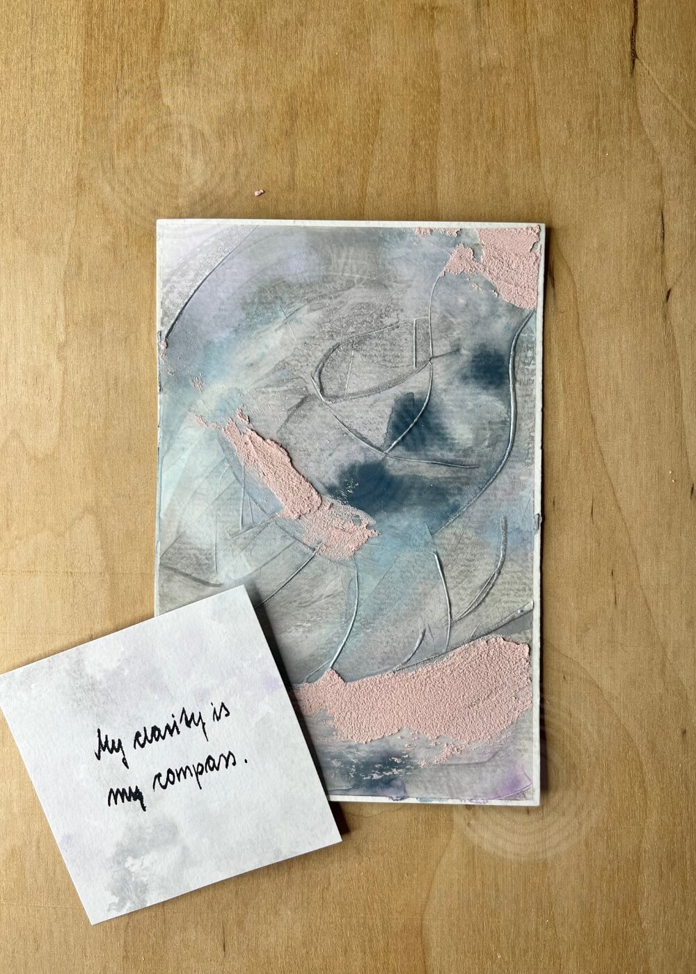 The artwork Between the Inhale and the Exhale displayed with a handwritten affirmation reading ‘My clarity is my compass,’ reflecting centered awareness between calm and motion.