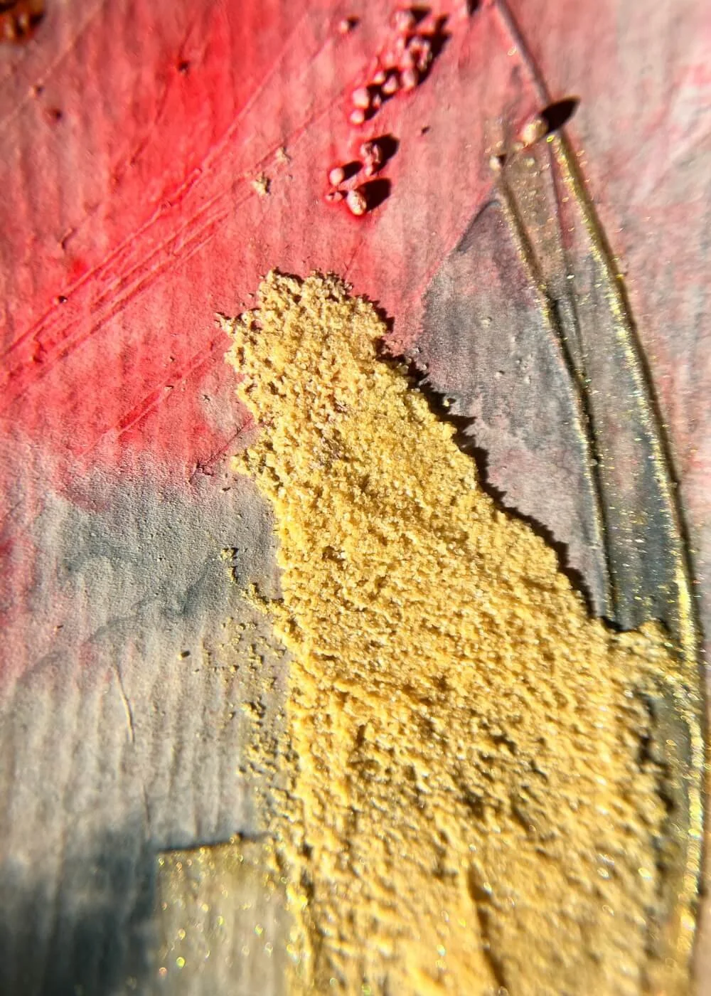 A close-up reveals glowing pigments and tactile ridges — the trace of burning turning tender under the light.