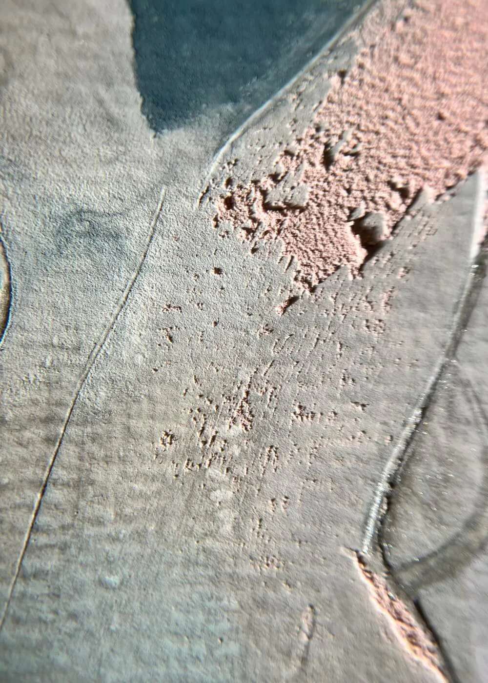 Macro detail revealing the meeting of rough blush texture and smooth grey-blue pigment, symbolizing the shift from tension to calm.