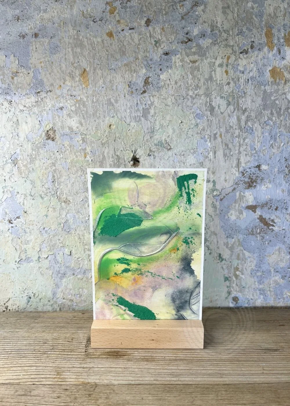‘In the midst of transition’ – abstract artwork from the Silver Feathers Rising series, with layered green, violet, and golden textures symbolizing change and renewal.