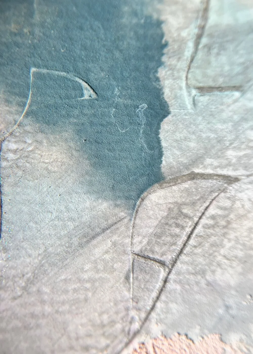 Detailed close-up of soft pink and teal textures blending on rough plaster, emphasizing tactile depth and the gentle rhythm of stillness within the artwork.