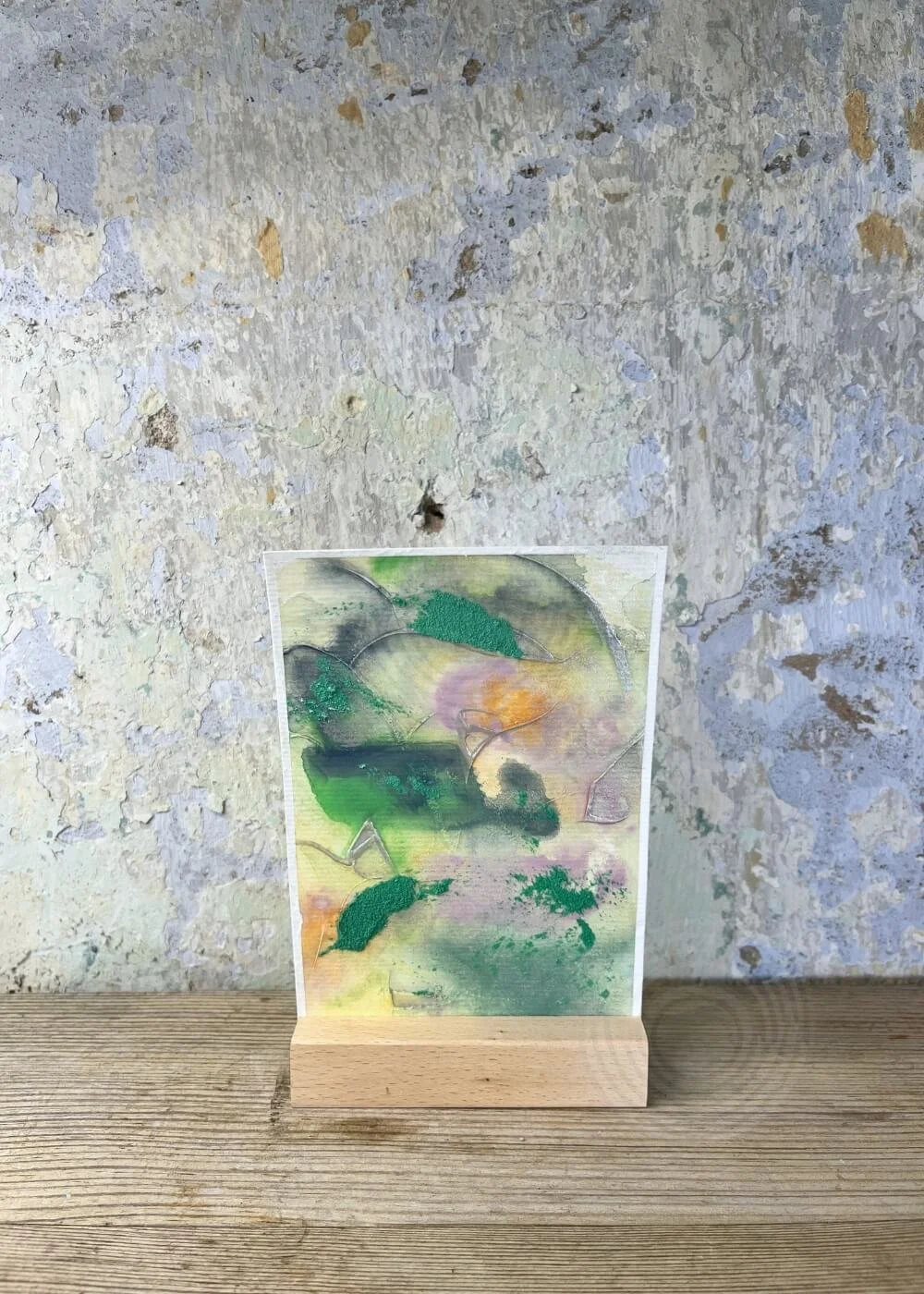 Abstract artwork ‘And something in me begins to flow’ from Silver Feathers Rising series – textured layers of green, orange, and lilac evoking renewal, healing, and release.