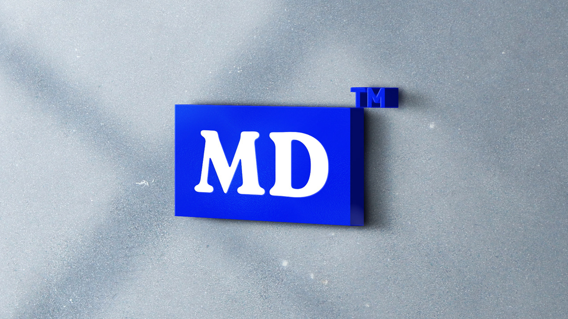 Logotipo de marca con letras blancas 'MD' en fondo azul y marca de registro 'TM' en esquina superior derecha.