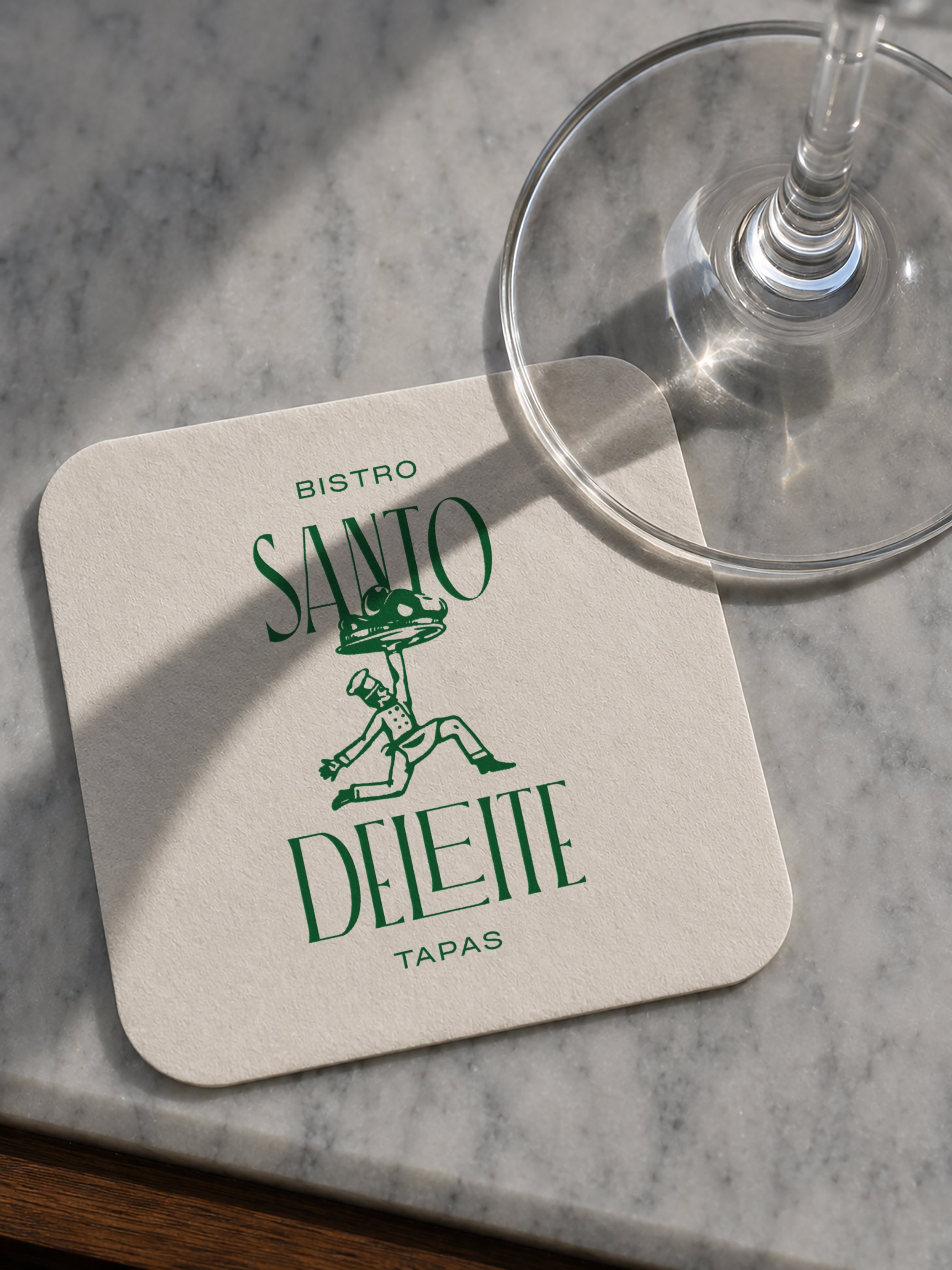 Una carta del bistró Santo con un personaje que lleva un sombrero y cadenas, y un vaso de vino sin líquido en una mesa de mármol.