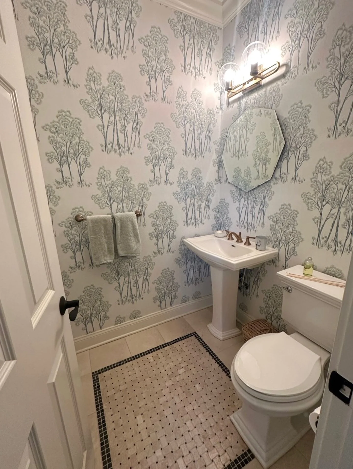 Before &amp; after of this powder room refresh

Adding wallpaper completely transformed the space