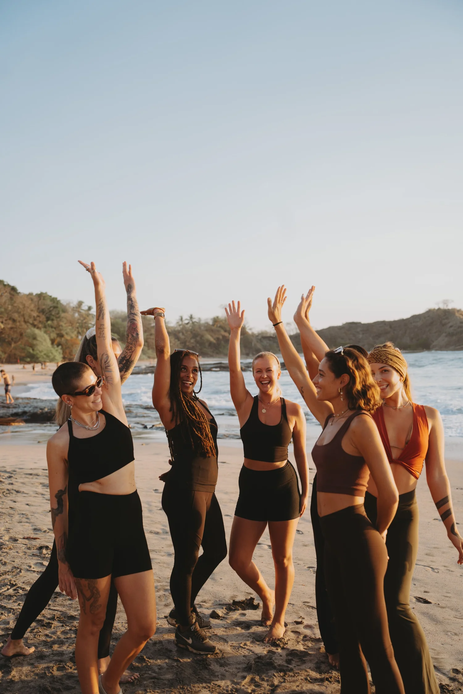Black Cat Studio retreat group celebrating on the beach in Nosara