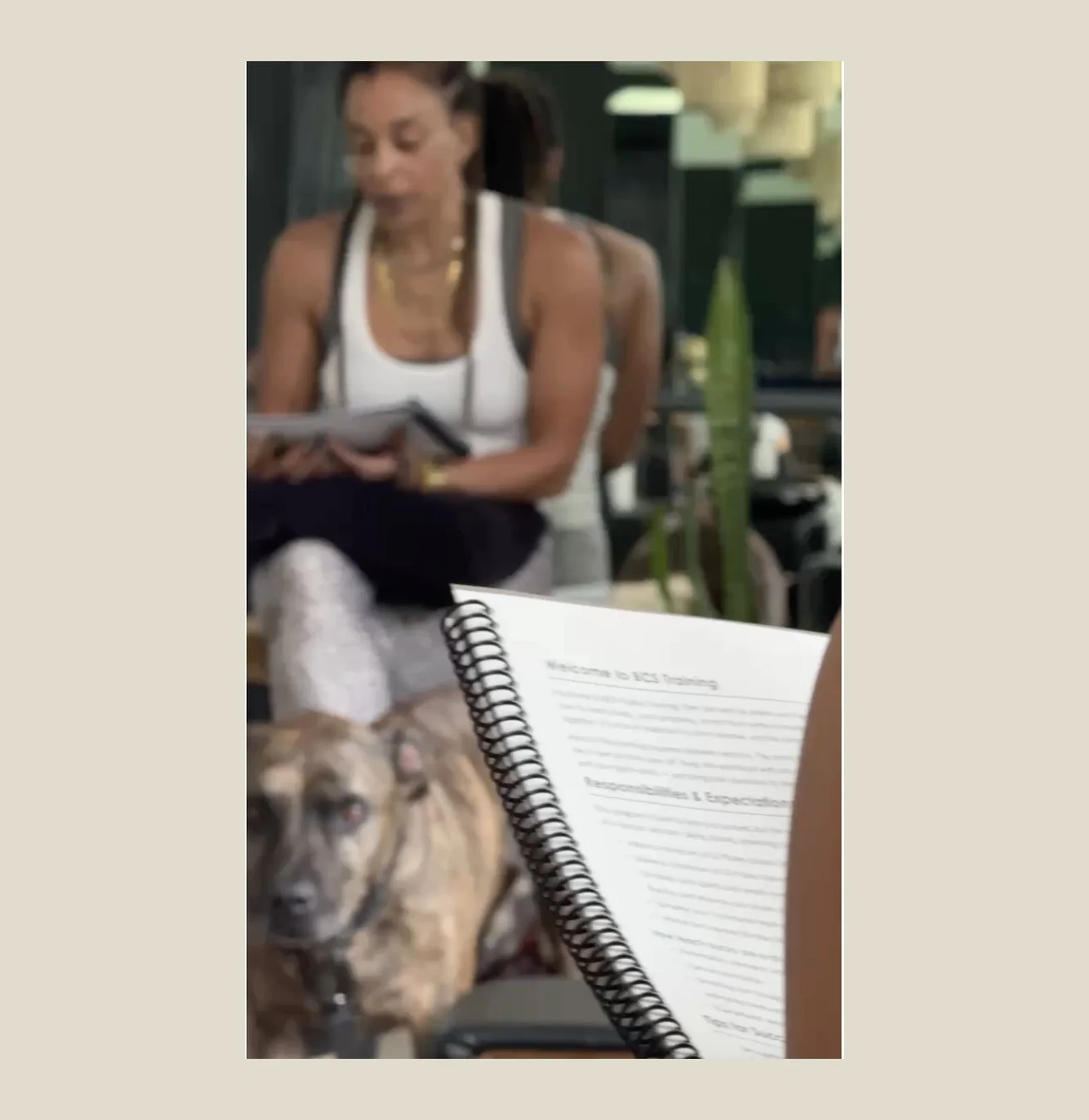 Instructor reviewing the Black Cat Studio reformer instructor training manual in Nosara