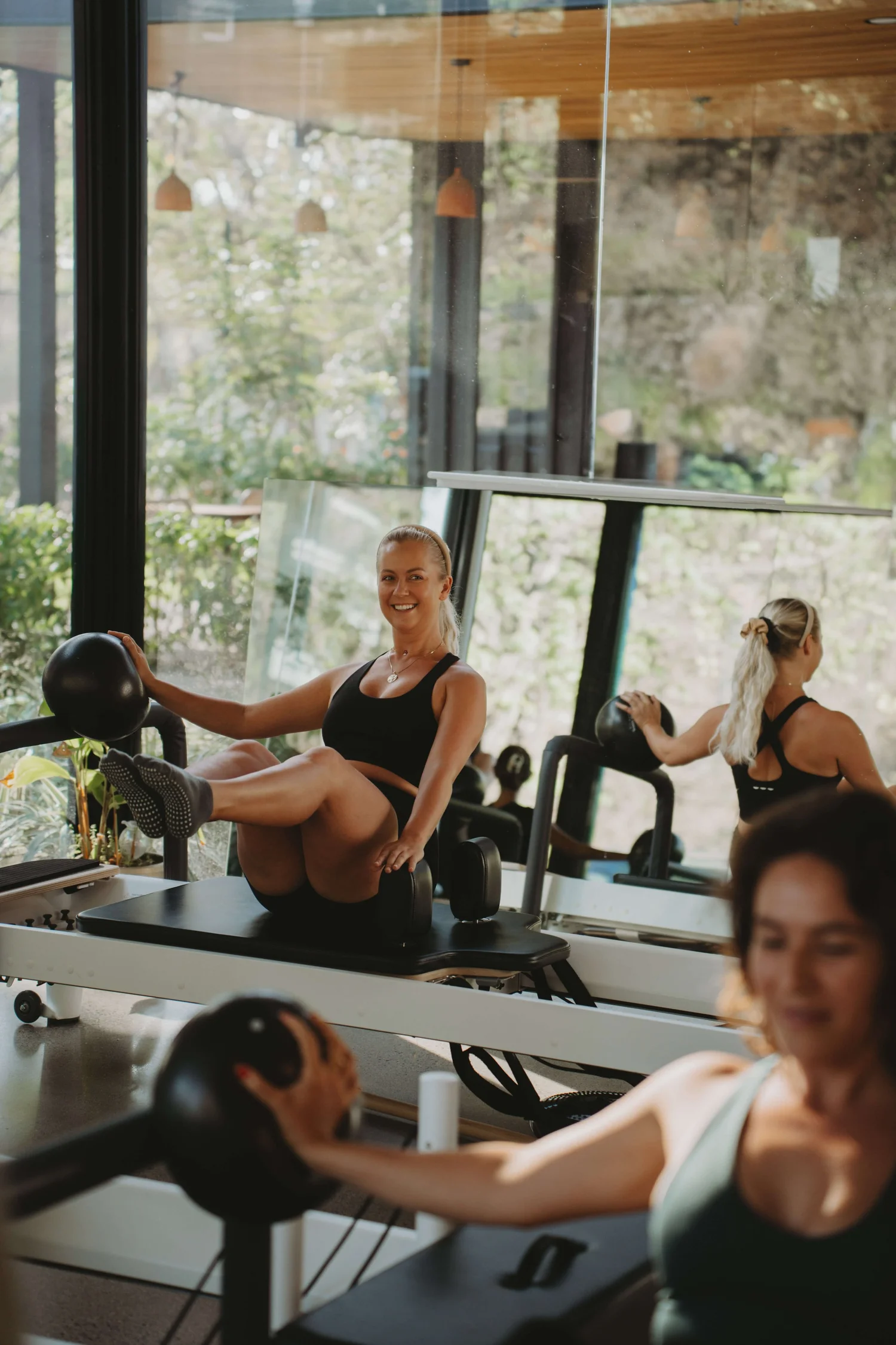 Clients training with weights during a class at Black Cat Studio, Nosara