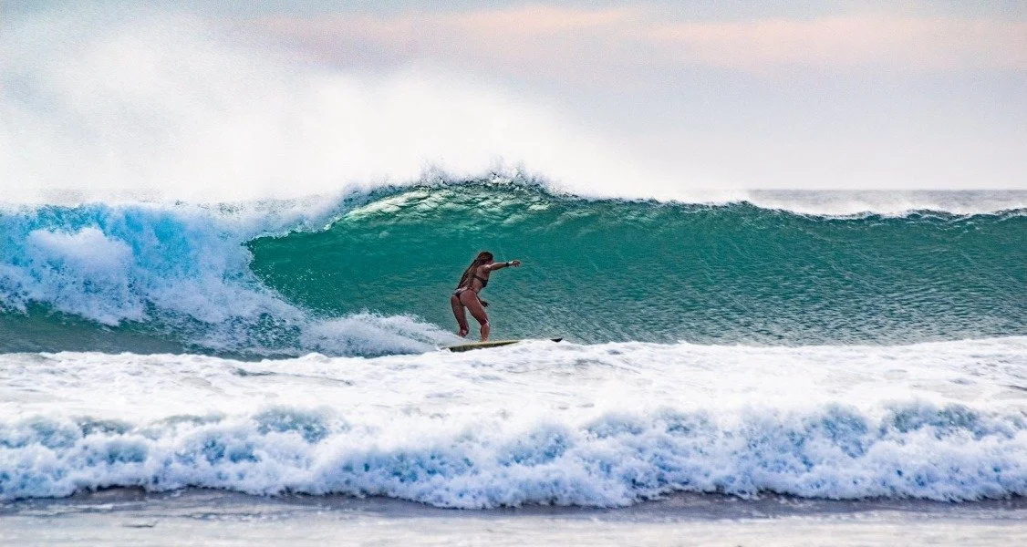 Surfer riding a wave in Nosara, Costa Rica