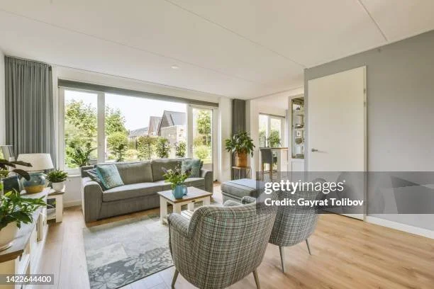A peaceful, organized living space with warm natural light, creating a comfortable and manageable home after downsizing.