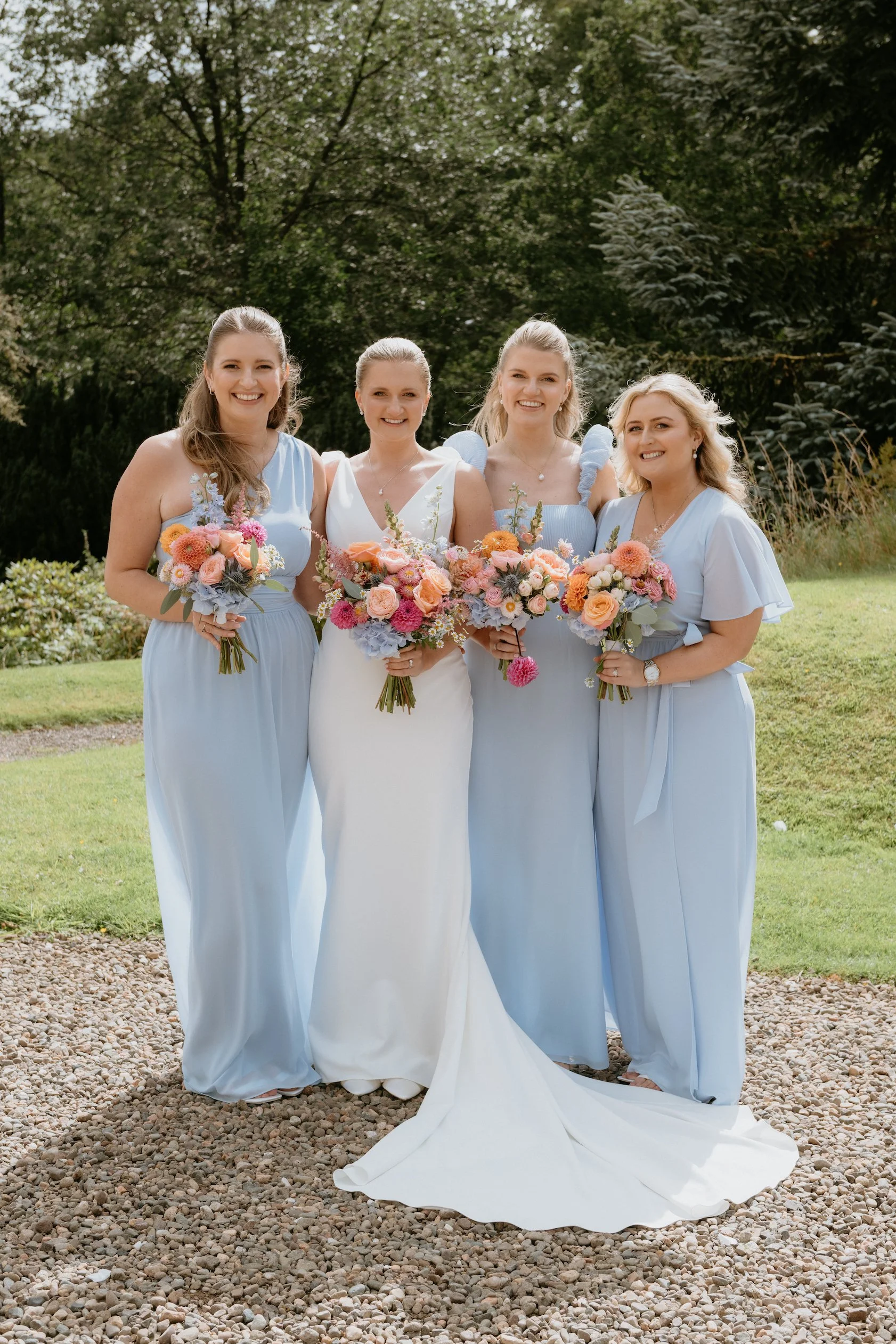 baby-blue-bridesmaids-with-summer-wedding-bouquets-newhall-estate-scotland.jpg