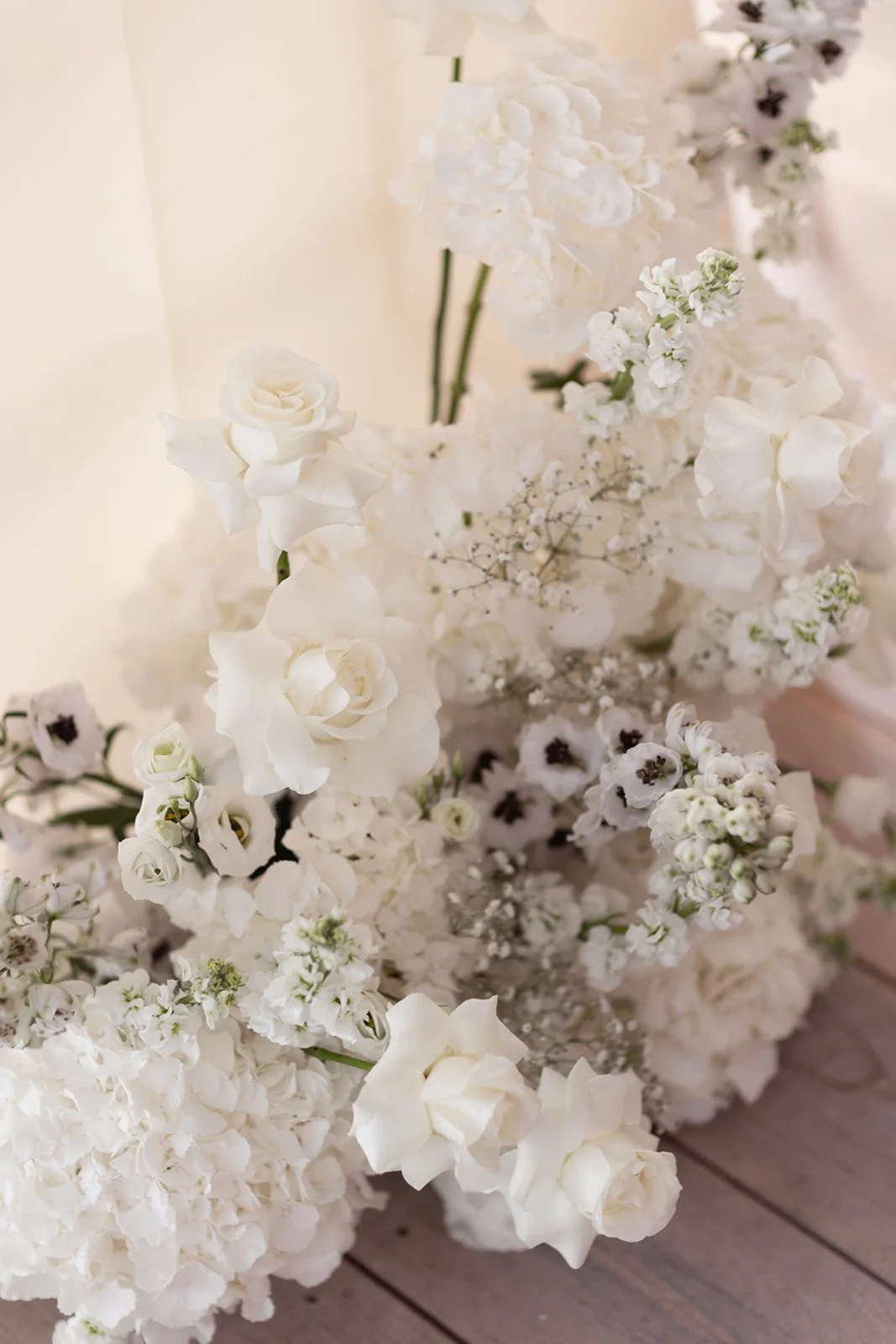 white-wedding-floral-display-with-fluxed-roses-hydrengeas-delphiniums.jpg