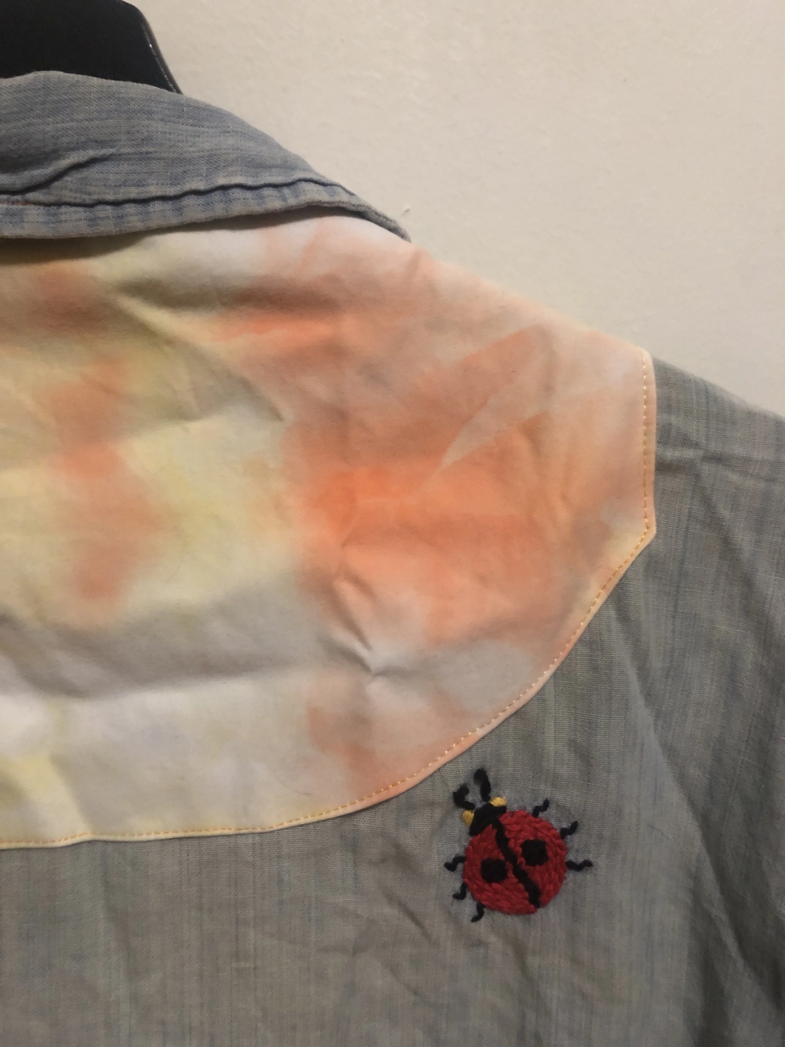holes from backpack straps - patched with ice dyed fabric