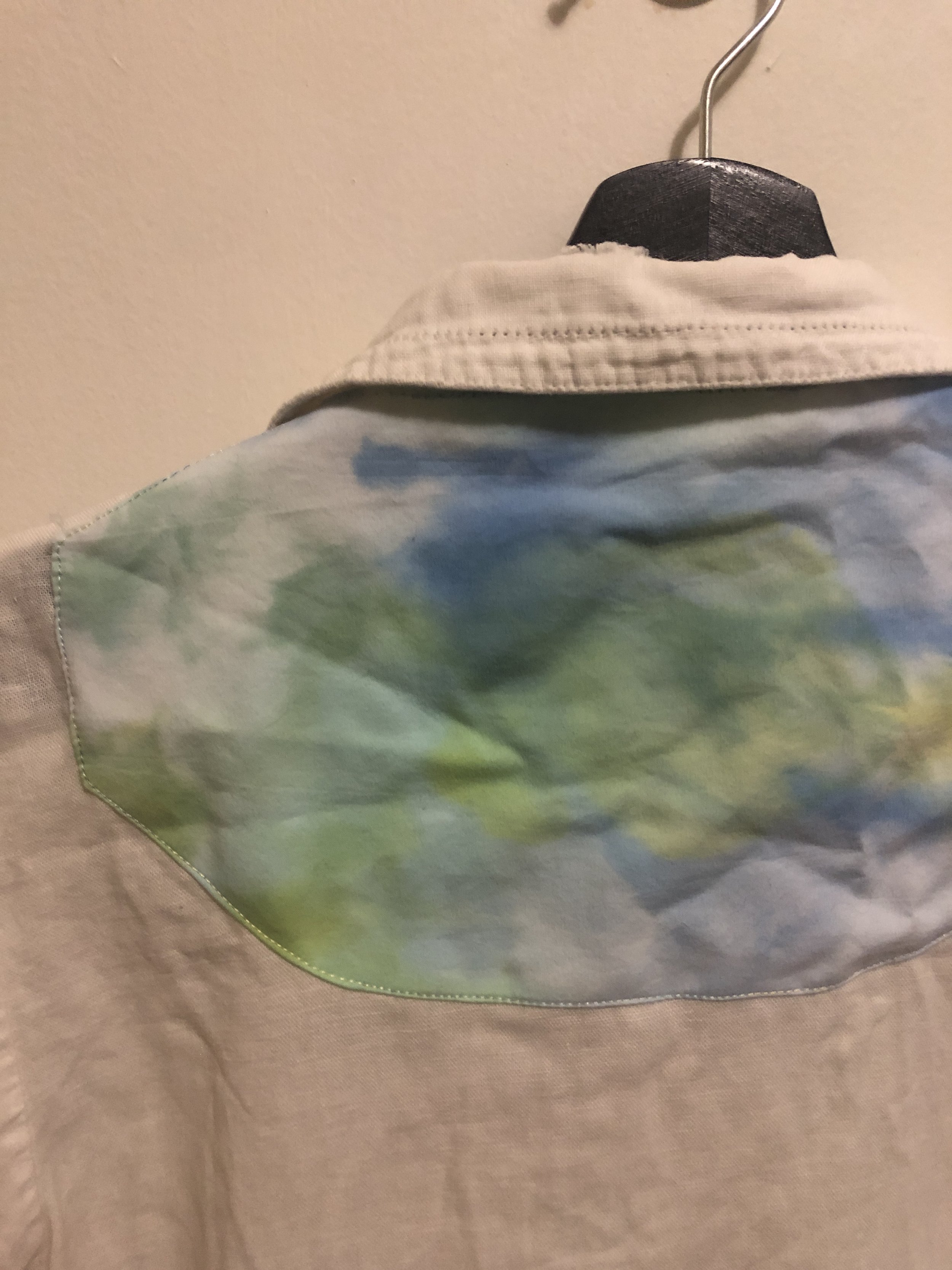holes from backpack straps - patched with ice dyed fabric