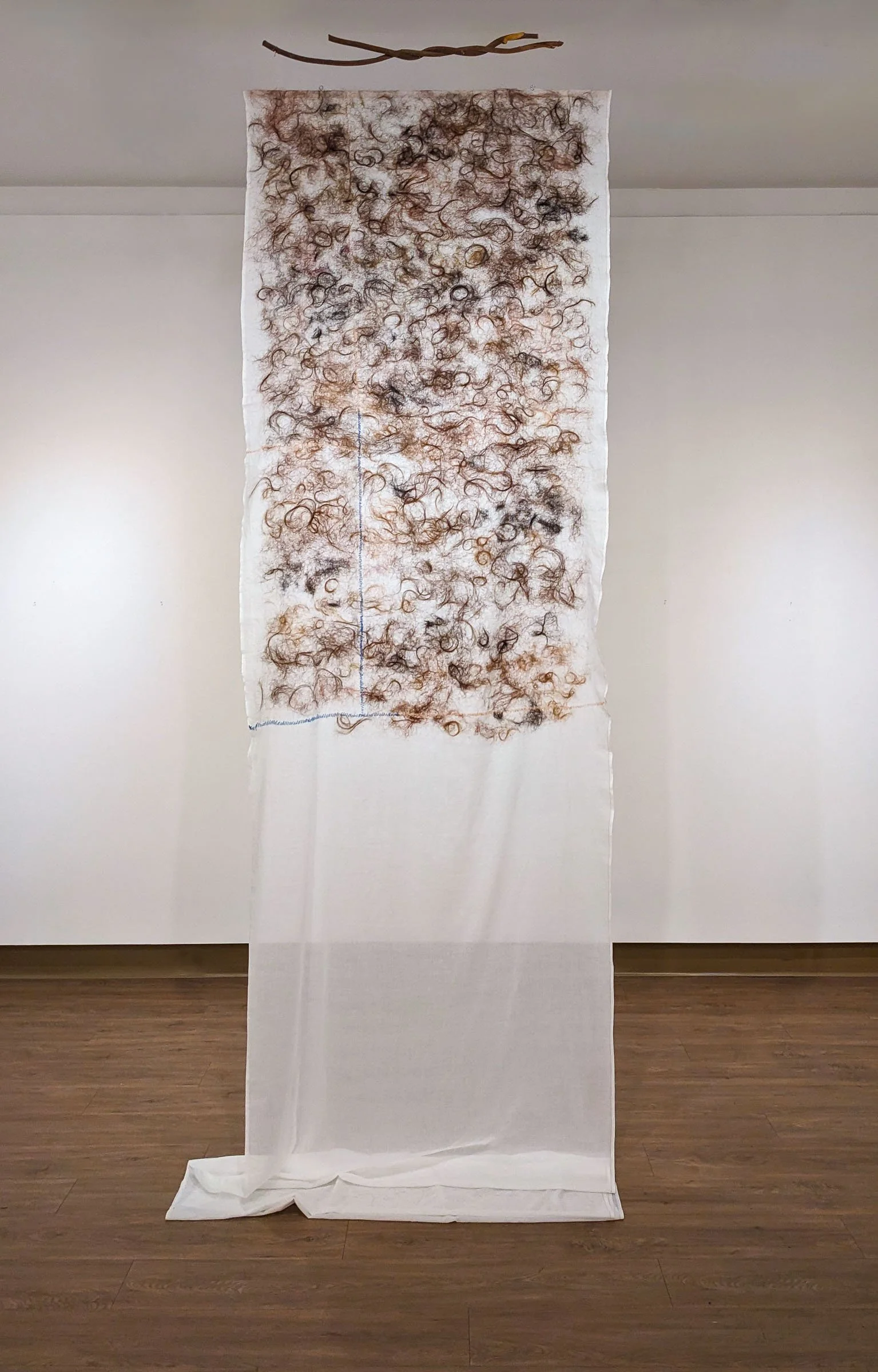 Suspended textile with felted human hair