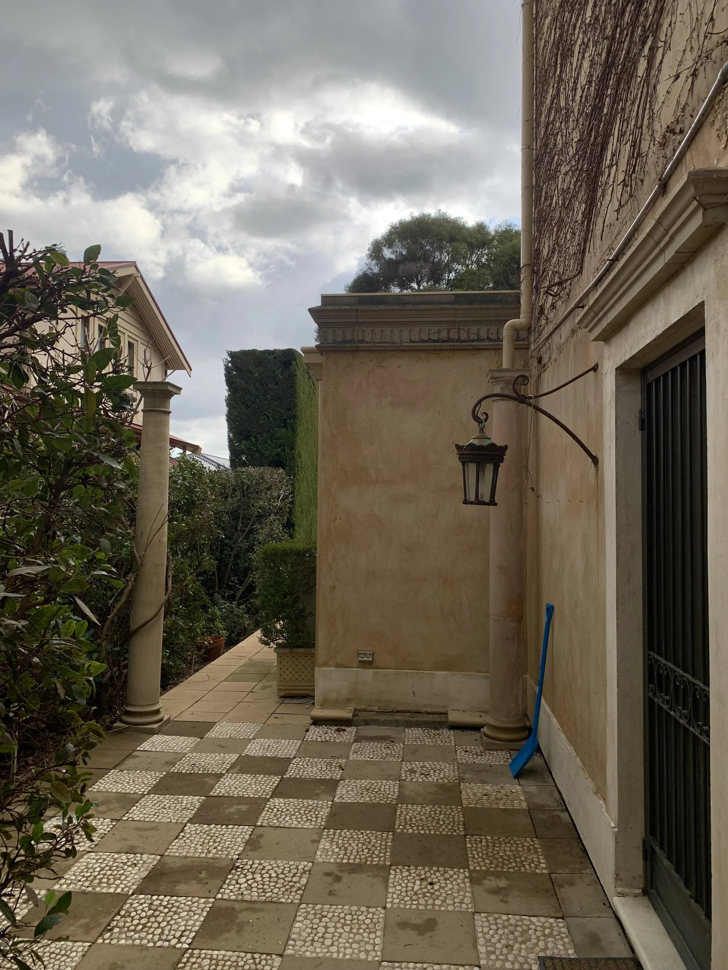 Construction of new pergola with detailed finishing on rafter ends and polycarbonate roof sheeting over side-entrance.