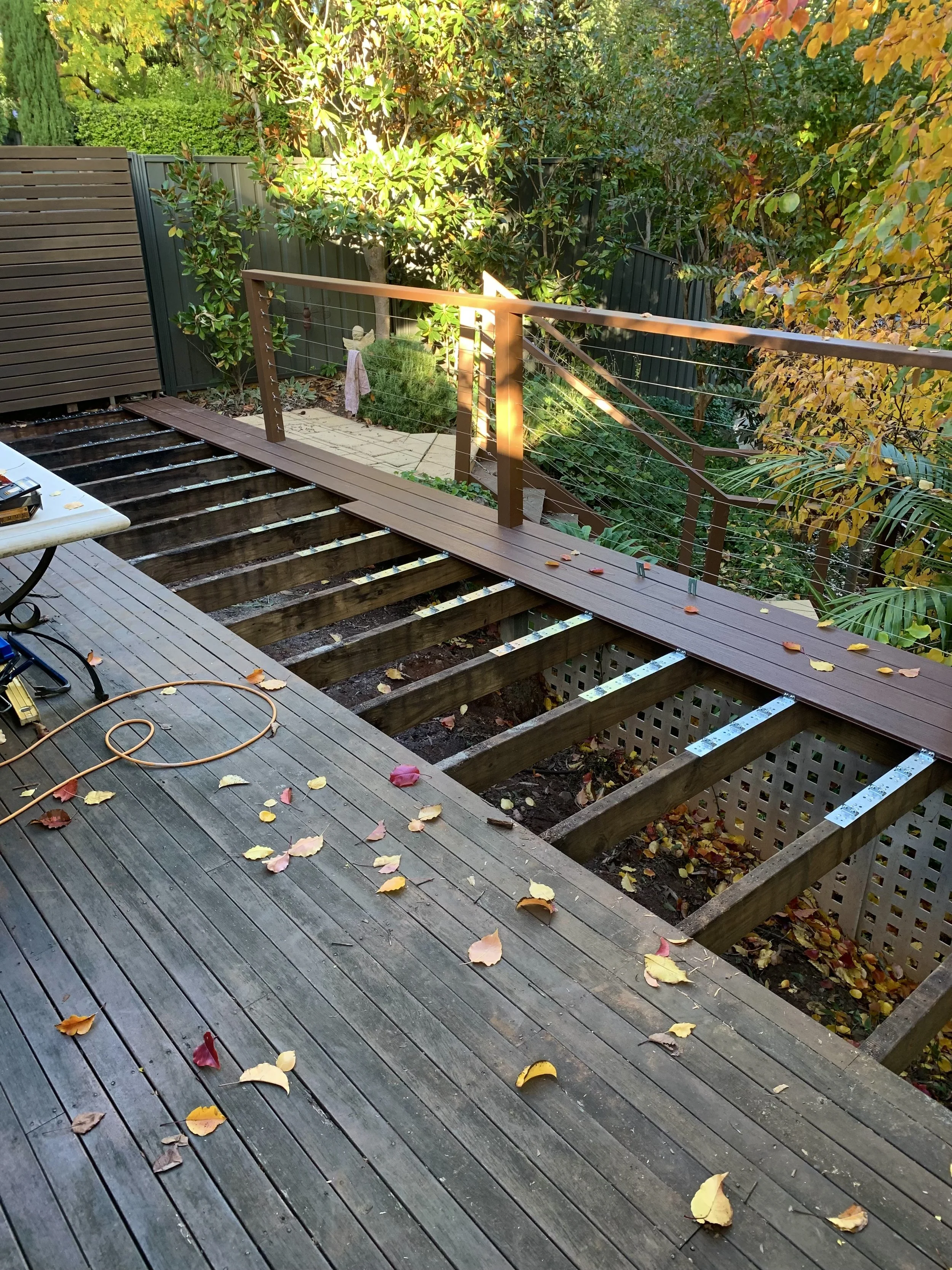 Removal of existing rotted hardwood deck and installation of new composite decking.