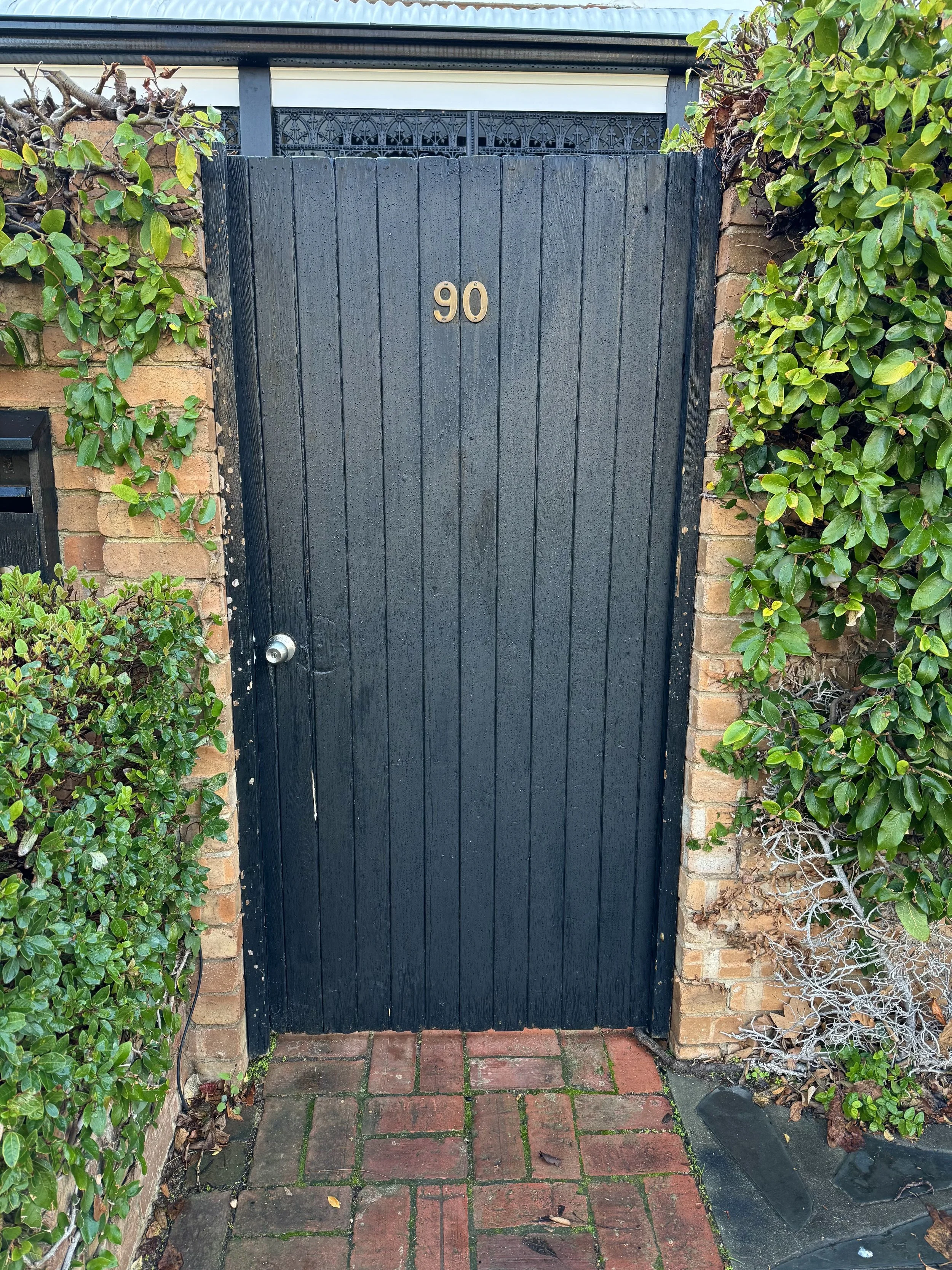 Replacement of front gate with a custom-built design, featuring a uniquely crafted window to enhance both the outlook and the connection between the property and the street.