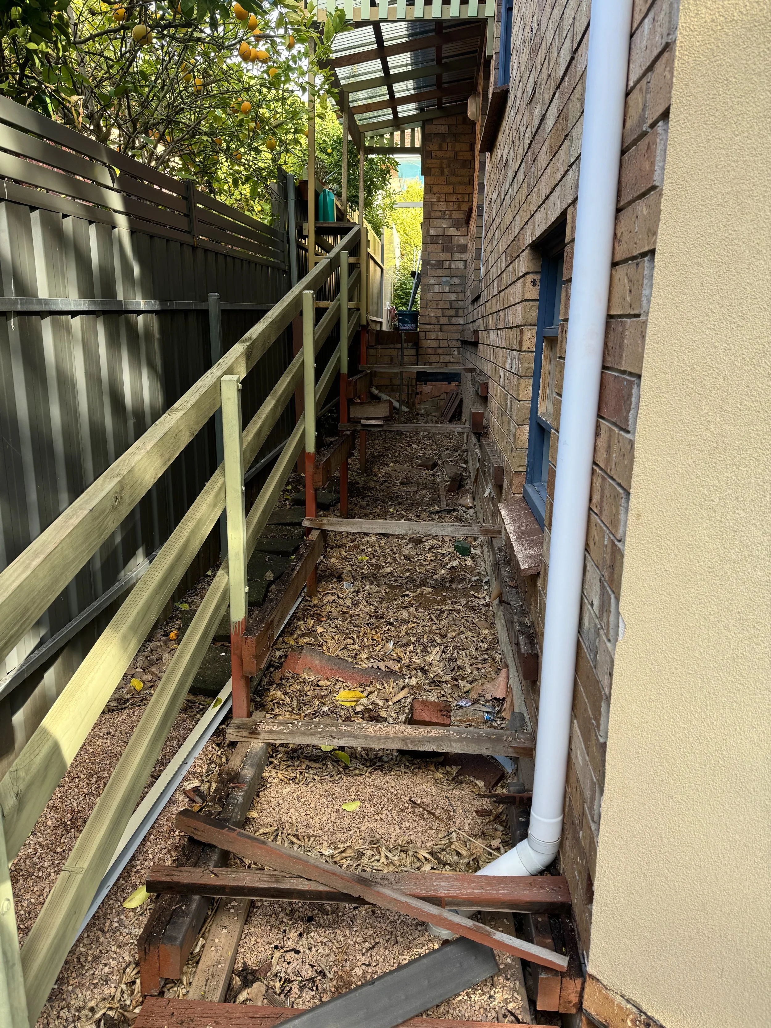 Replacement of hardwood framing platform and installation of new stairs using composite decking.