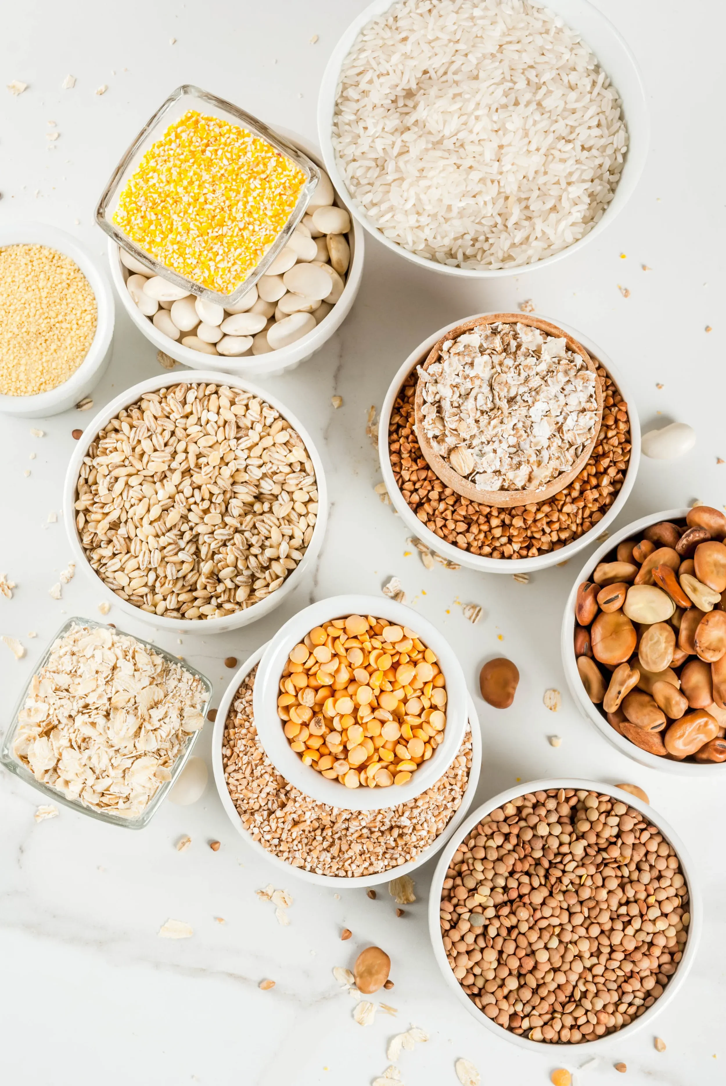 Legumes and a variety of grains in ceramic bowls
