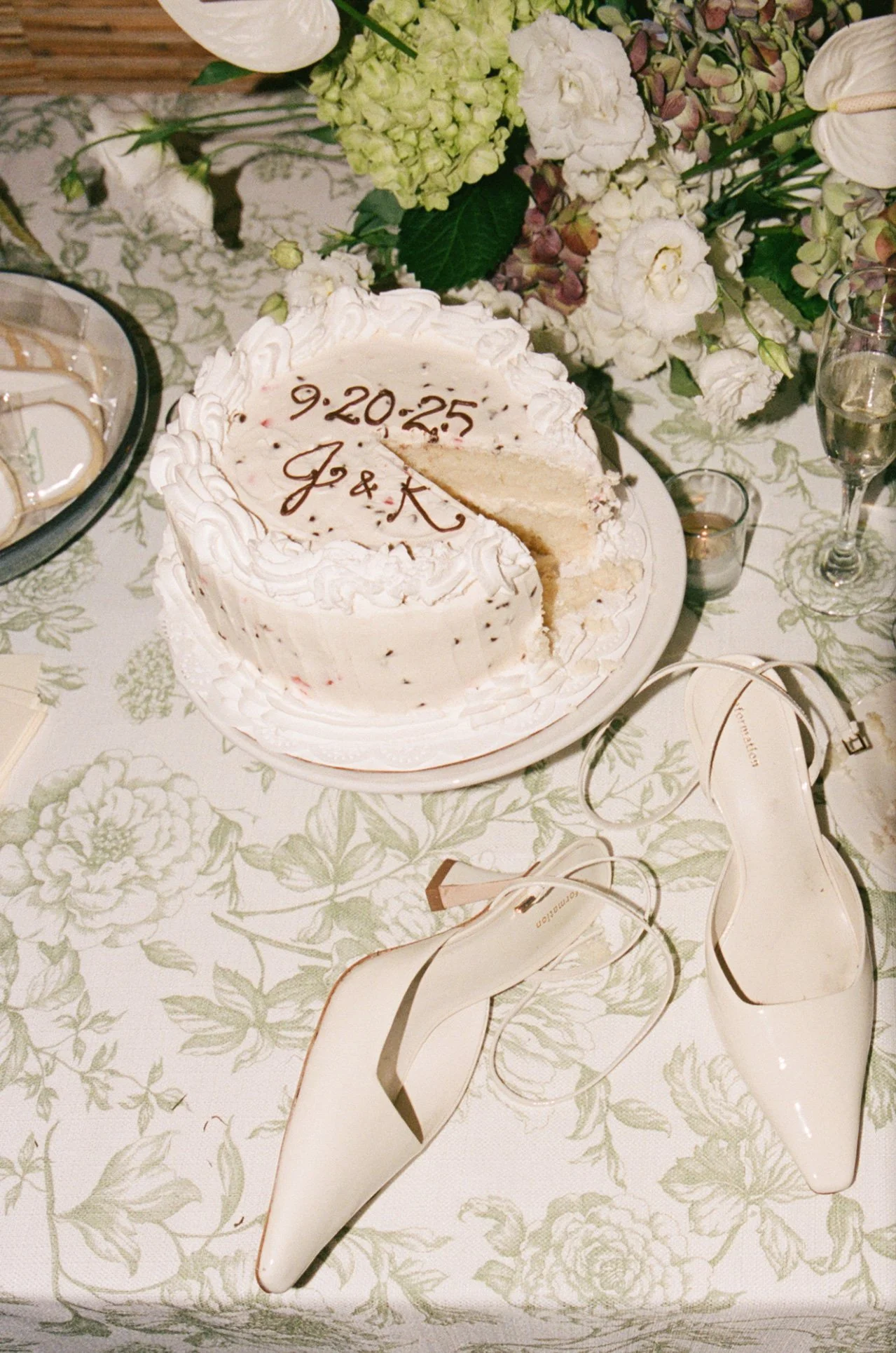 A black-and-white photo of a couple dancing in front of a building with large columns, steps, and marble walls.