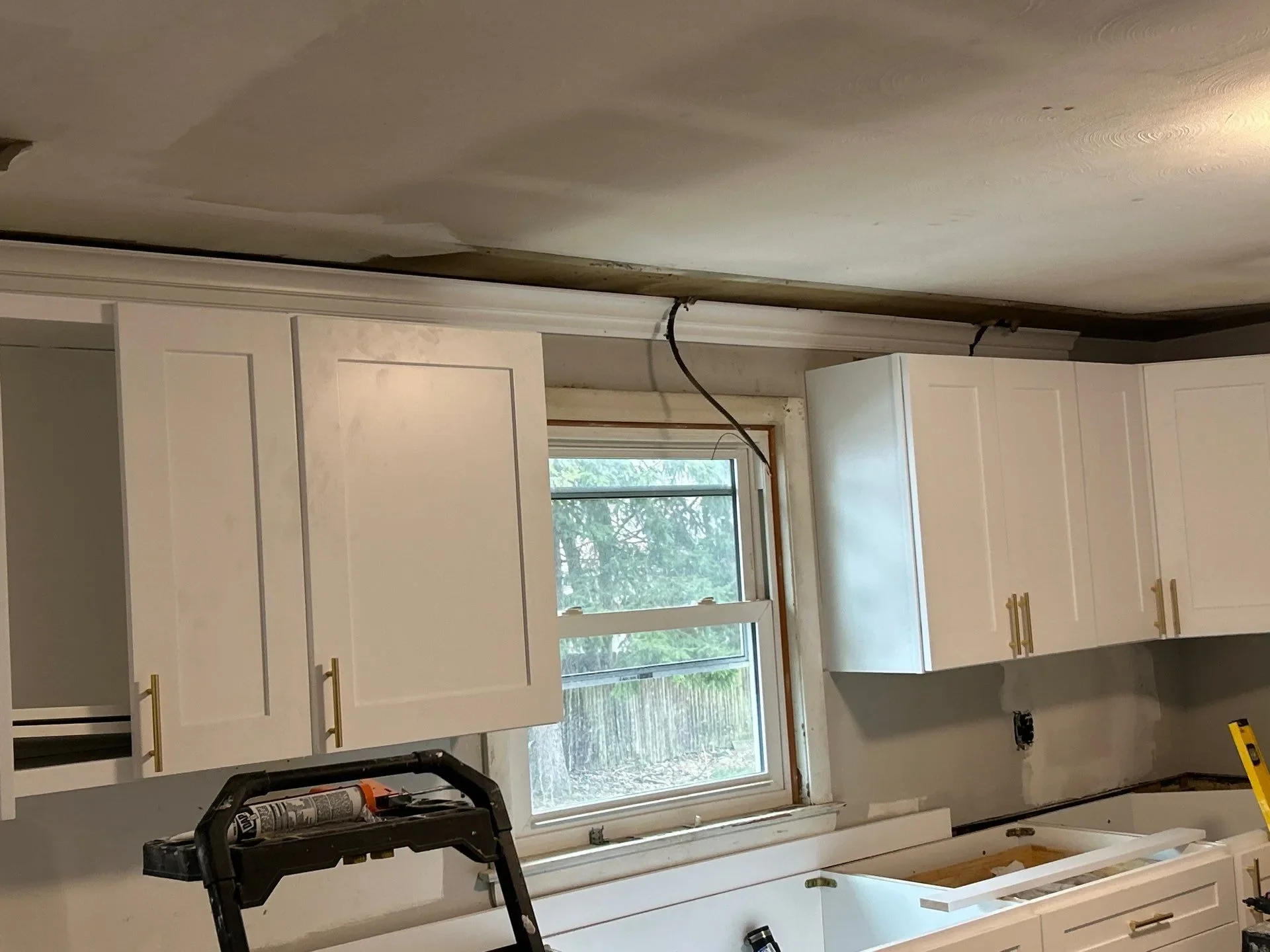 Kitchen cabinet installation in Meriden, CT — white shaker cabinets with gold hardware