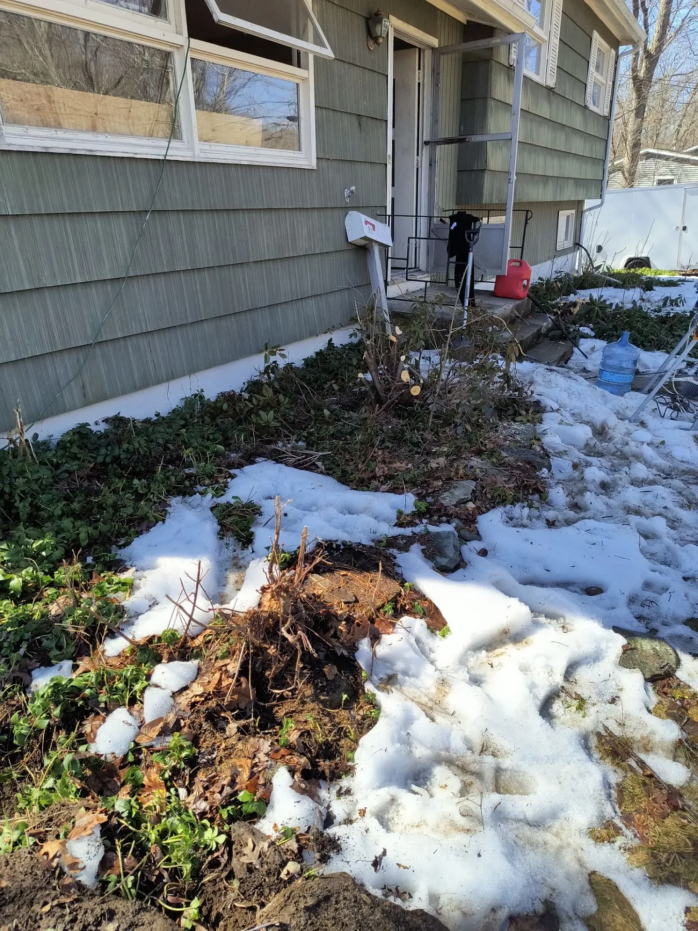 Residential spring cleanup service clearing flower beds after winter in Connecticut