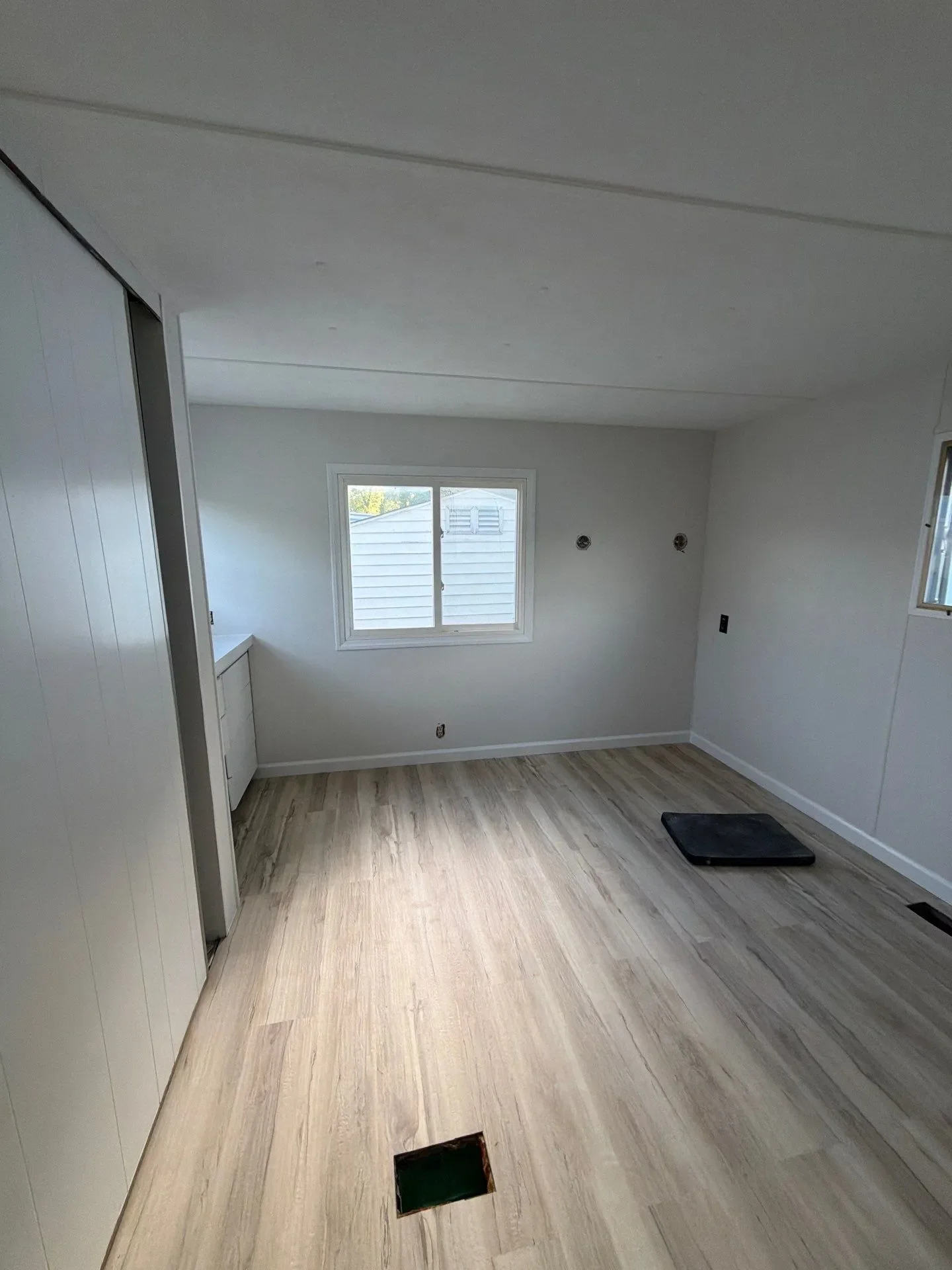 Finished bedroom after whole home remodel with new flooring and painted walls in New Haven CT