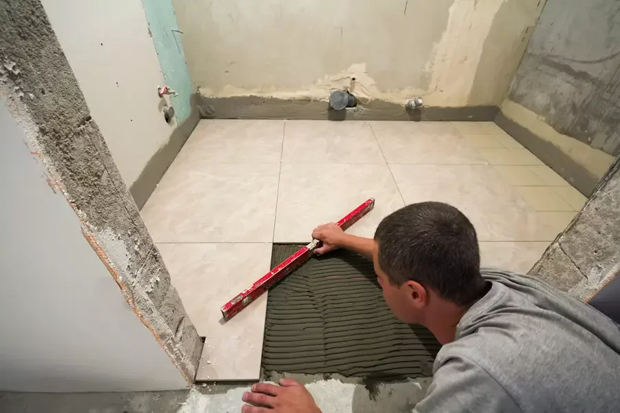 Bathroom floor tile installation during a bathroom remodeling project in New Haven, CT