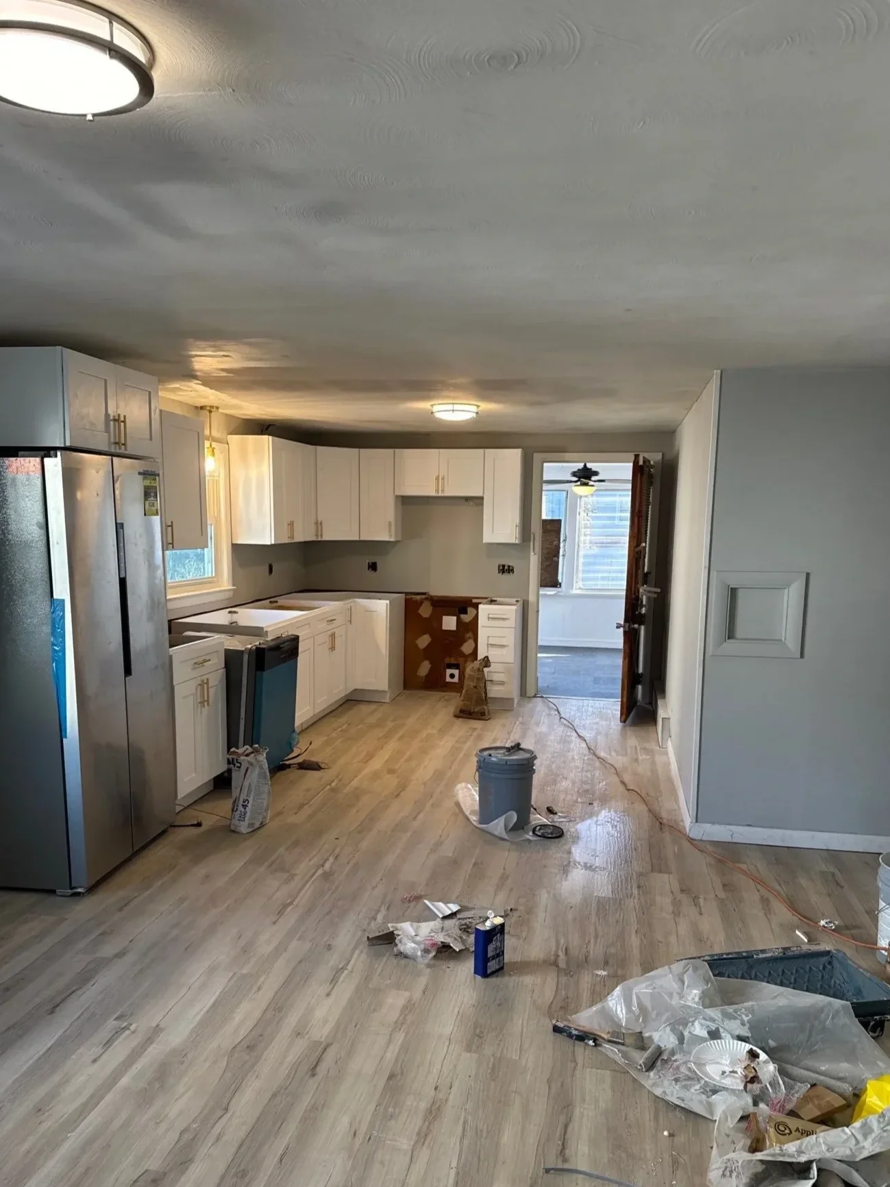 Kitchen renovation in progress in Meriden, CT with new LVP flooring and stainless appliances
