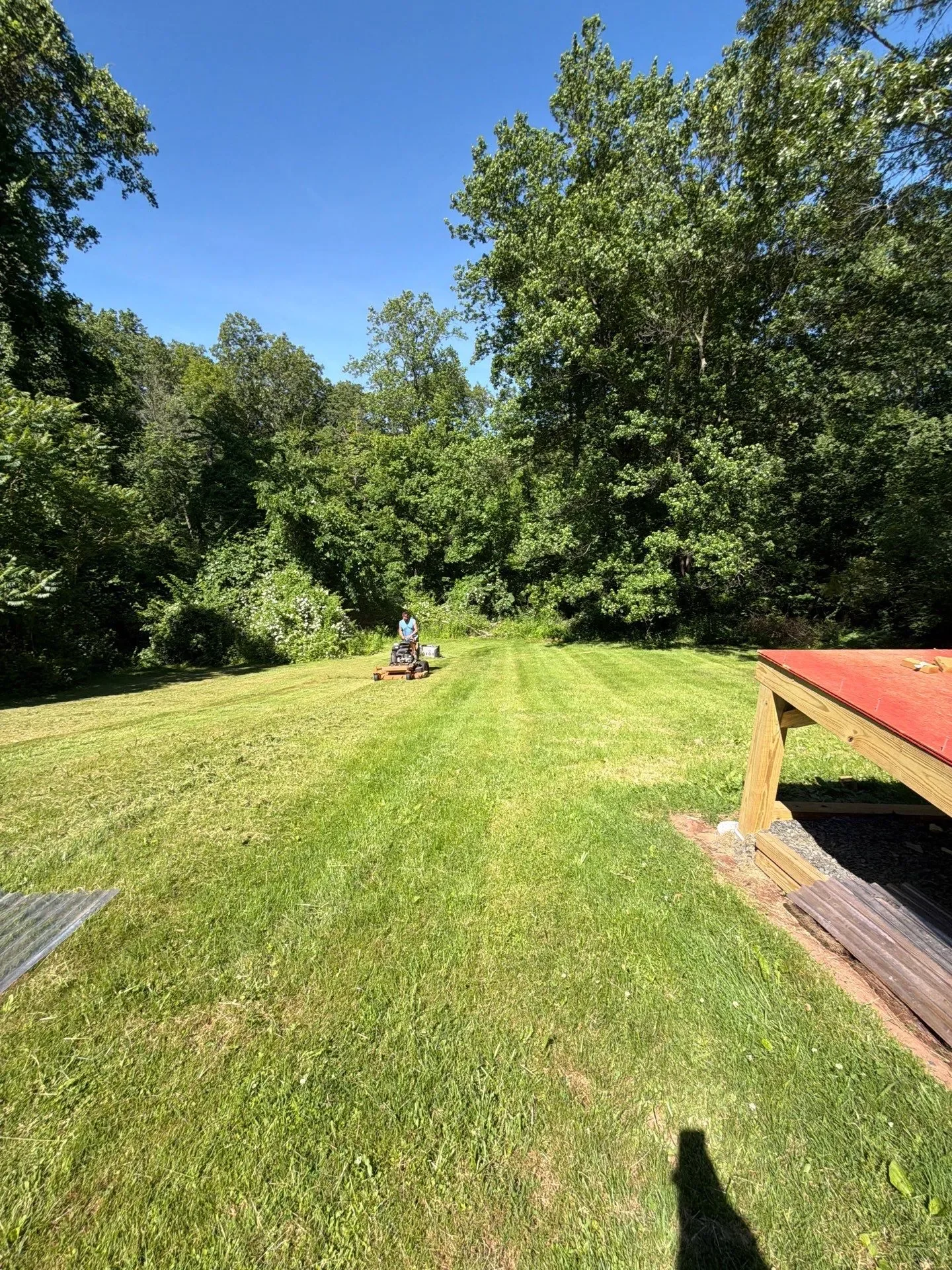 Lawn maintenance crew mowing a commercial property in New Haven County during summer