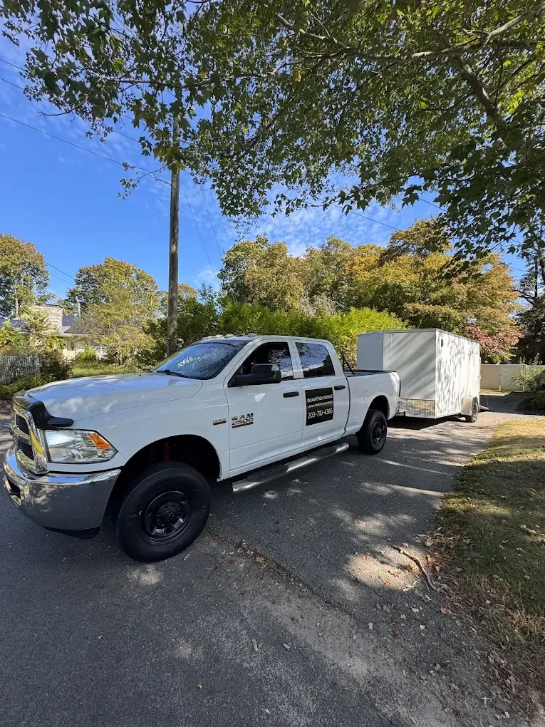Professional lawn care service, truck and trailer equipped for grass cutting, yard cleanup, and exterior maintenance. Ready to serve in Connecticut.